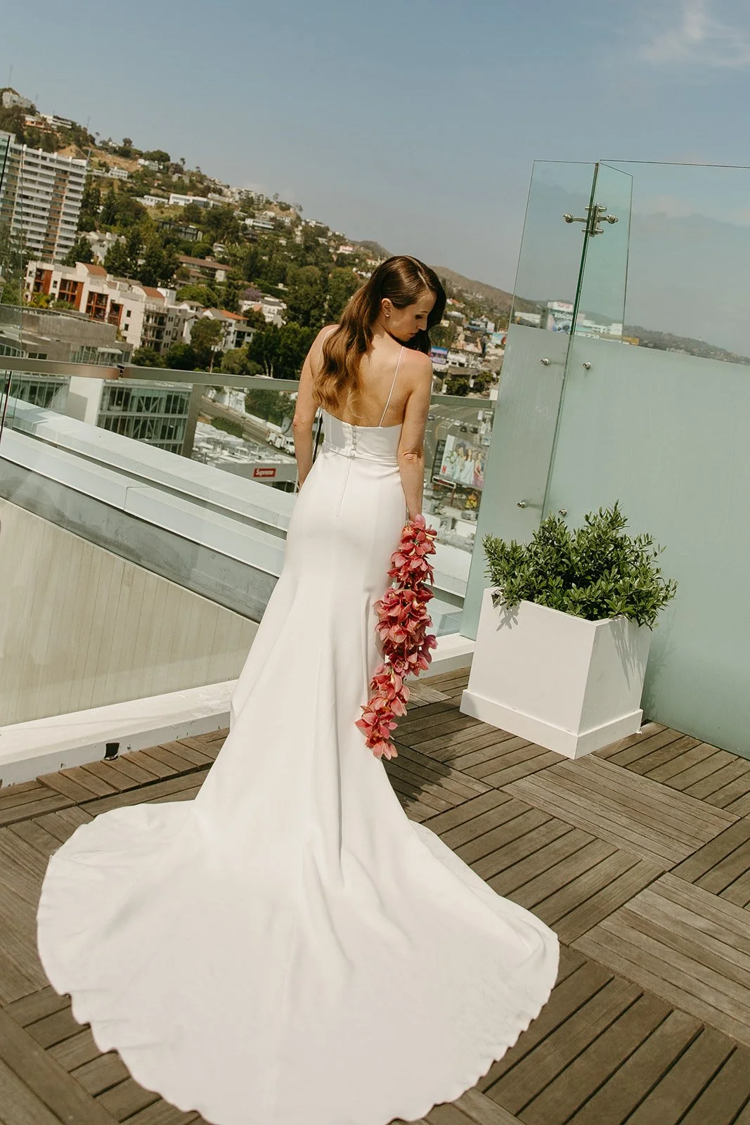 A bride posing for bridal portraits on the rooftop of the London, one of the best wedding locations in Southern California