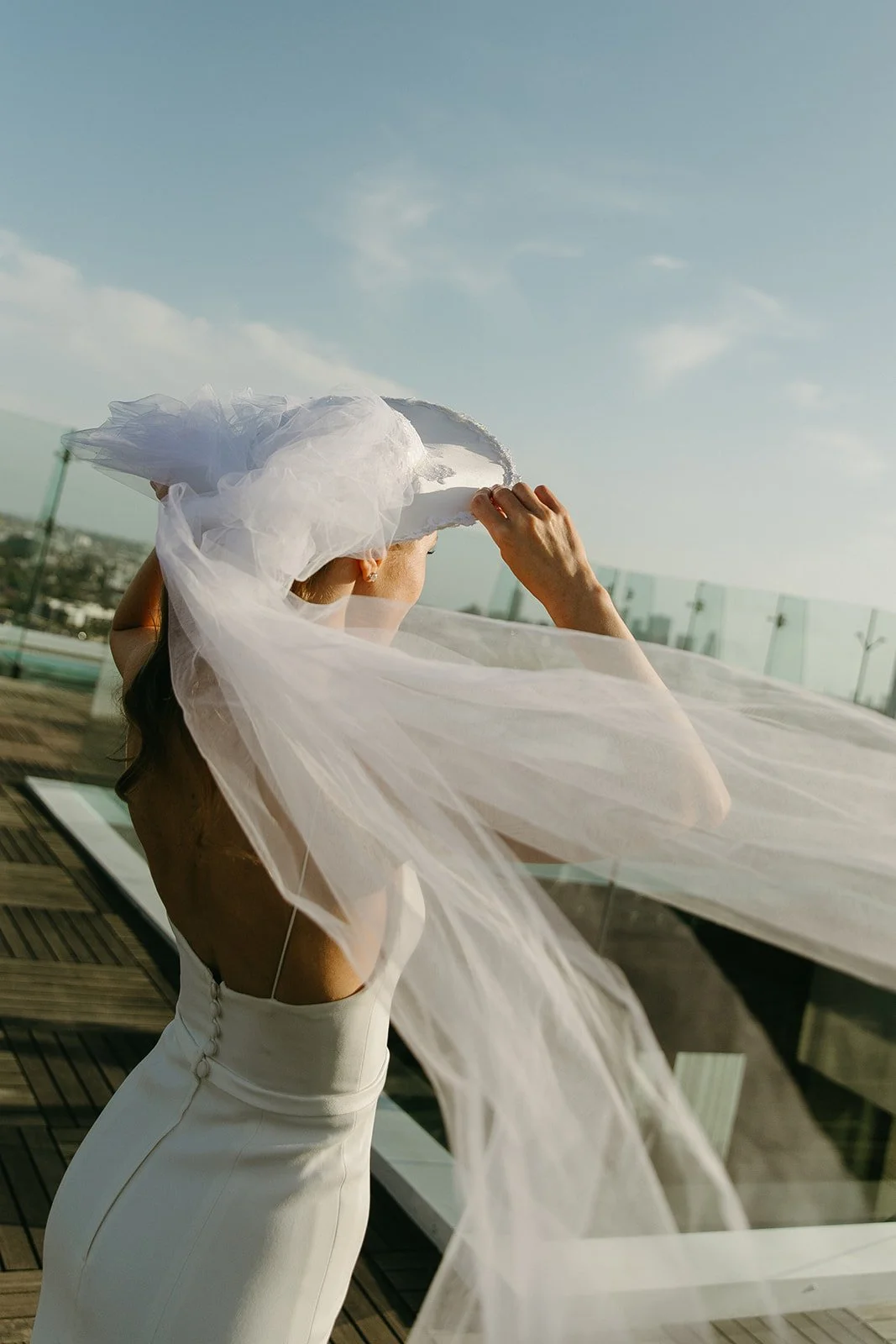 A bride posing for bridal portraits on the rooftop of the London, one of the best wedding locations in Southern California
