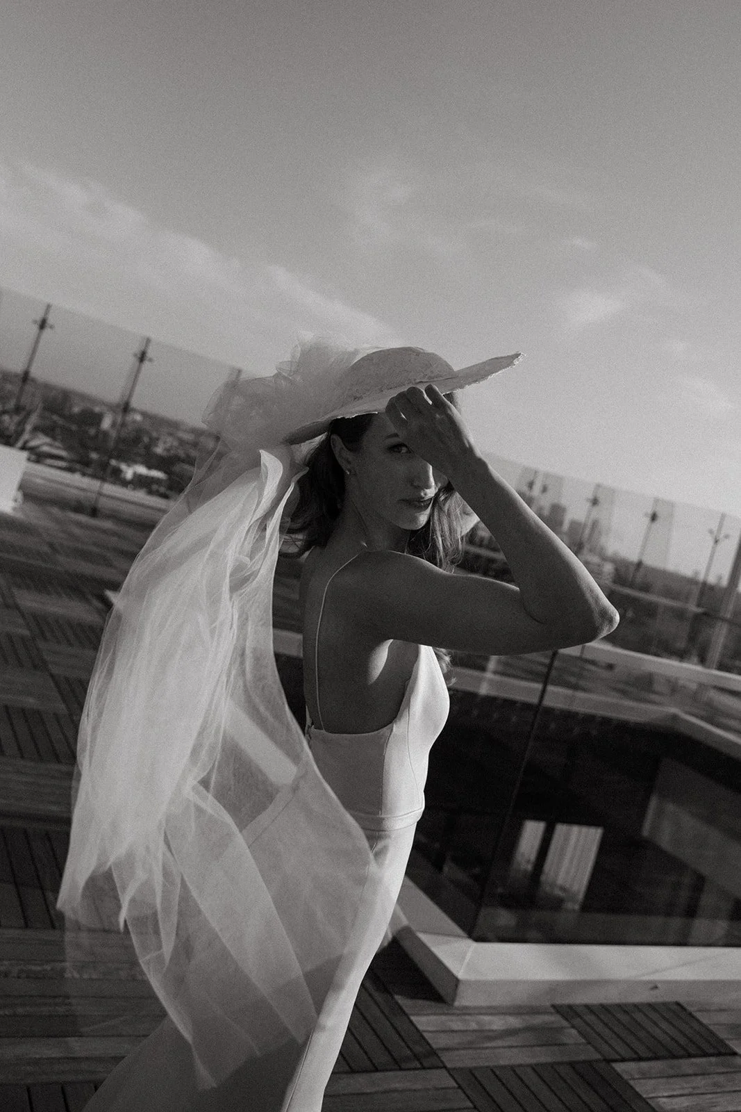 A bride wearing a bridal hat during wedding photos at her wedding location in southern california
