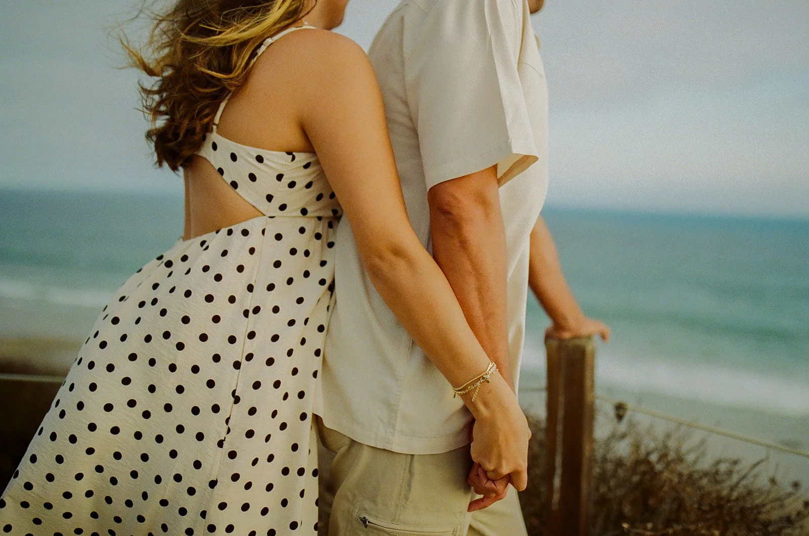 A couple in neutral engagement photo outfits showing what to wear for engagement photos