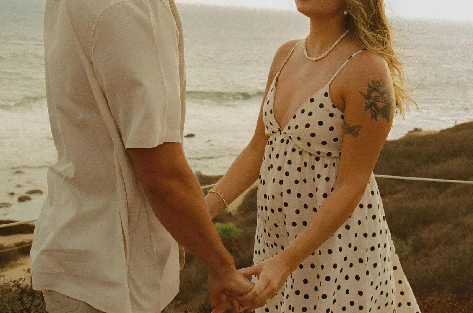 A couple in neutral engagement photo outfits showing what to wear for engagement photos