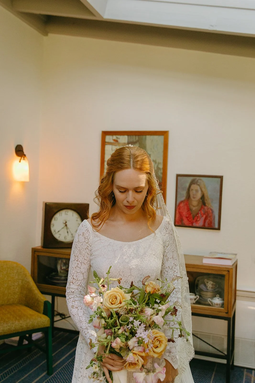 A bride wearing a long sleeve lace wedding dress