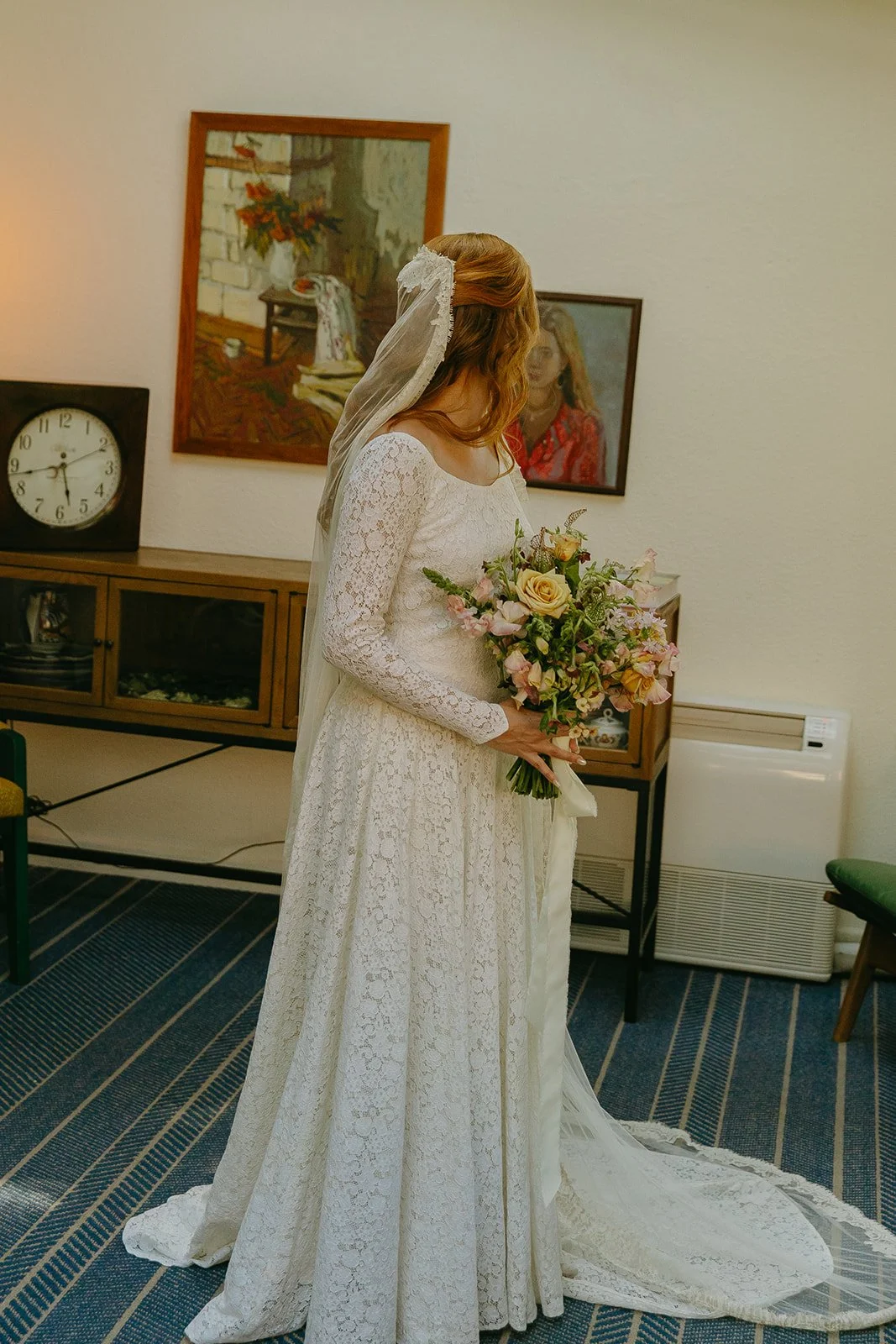 A bride wearing a long sleeve lace wedding dress