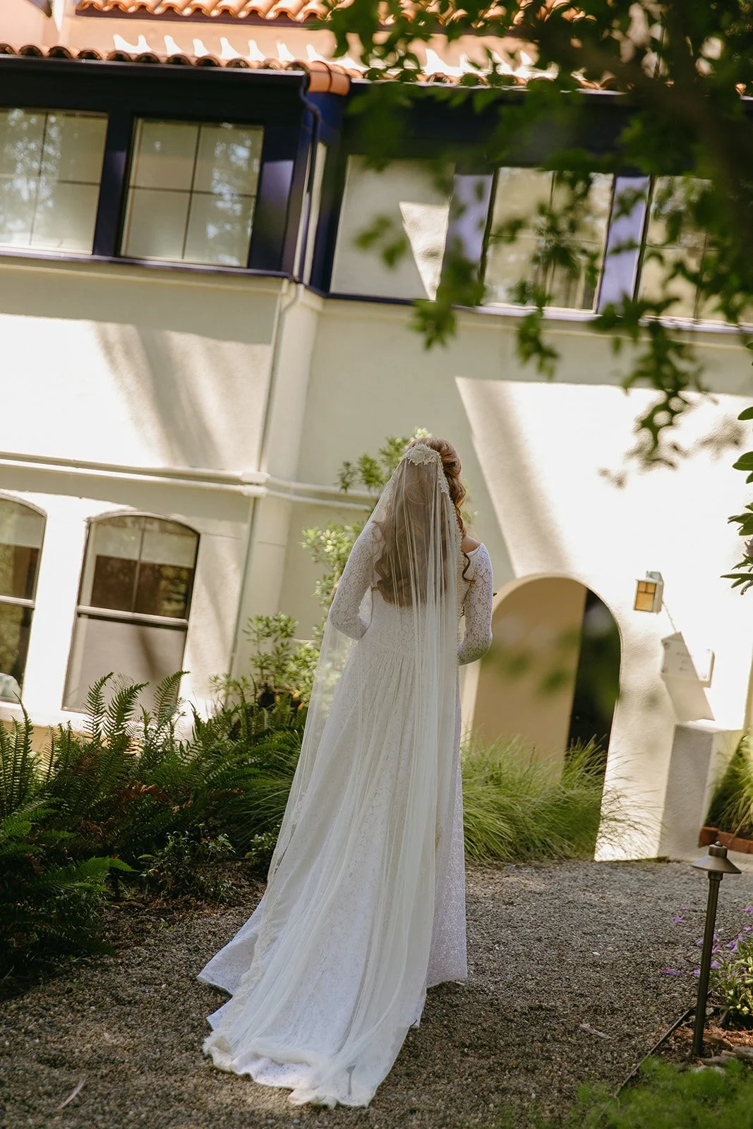 A bride walking in front of her wedding venue