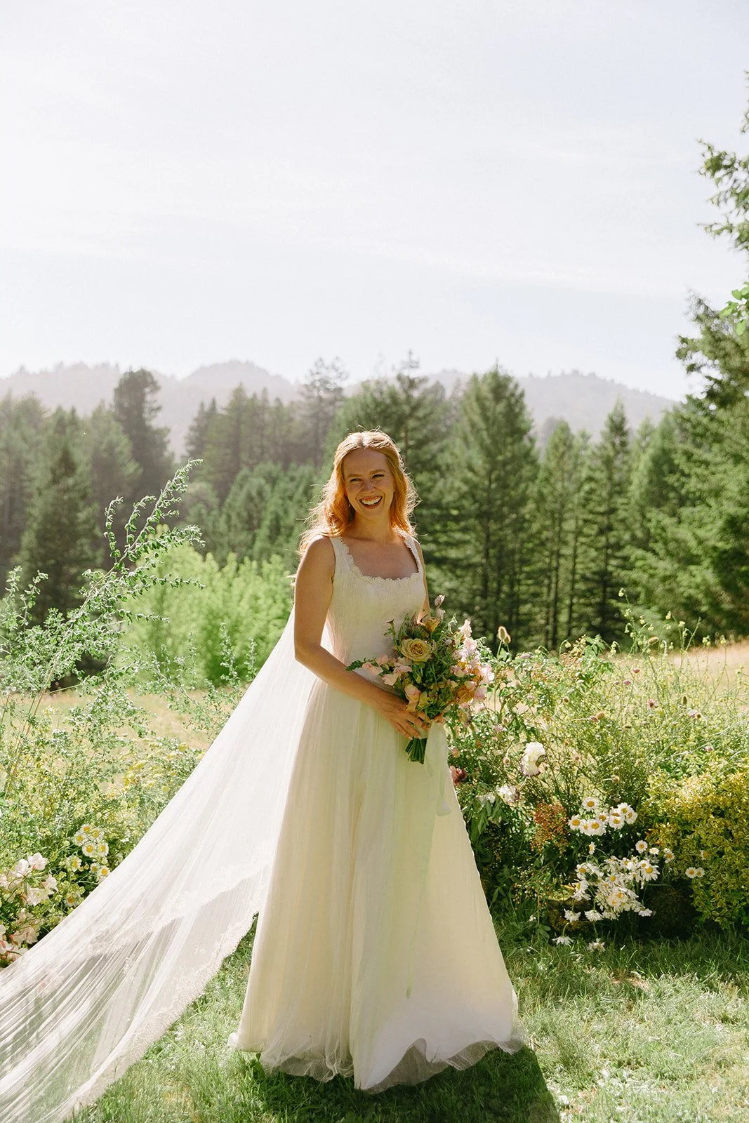 A bride posing for bridal portraits at her garden wedding