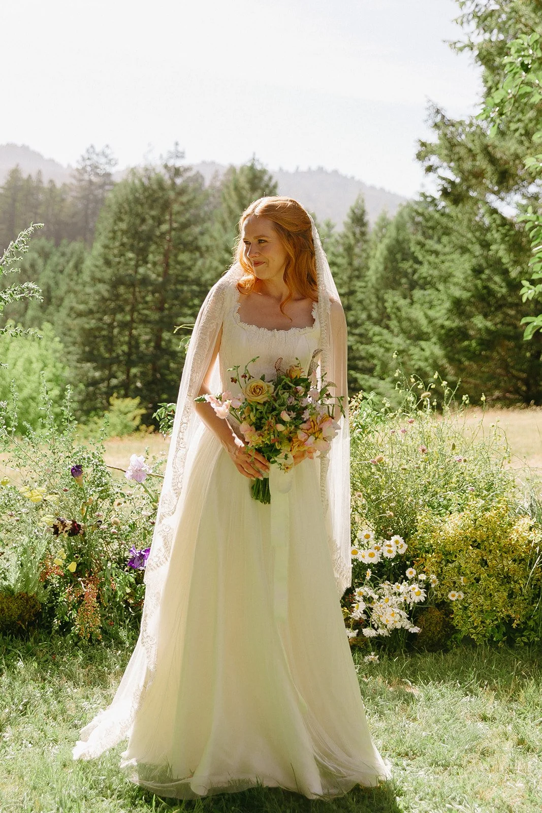A bride posing for bridal portraits at her garden wedding