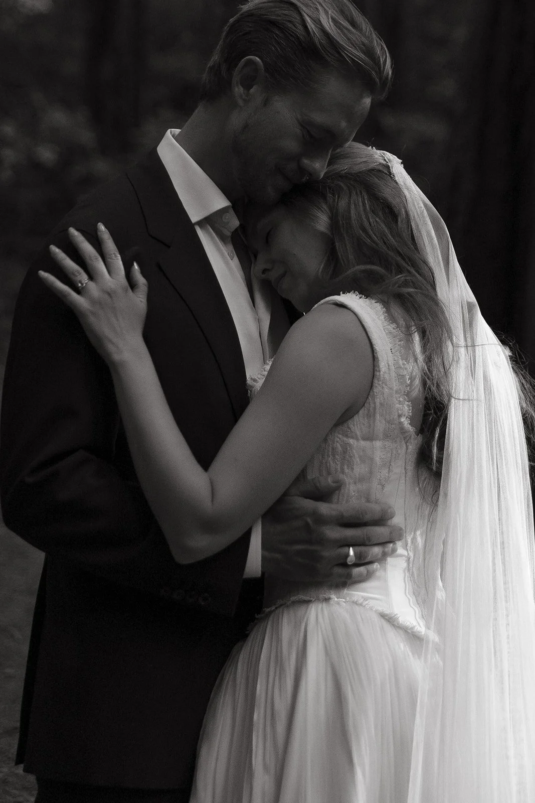A bride and groom taking romantic wedding photos