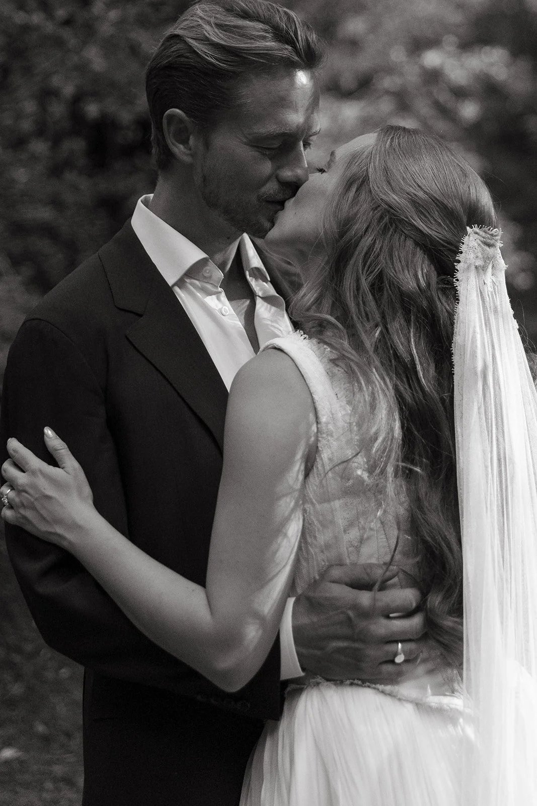 A bride and groom taking romantic wedding photos