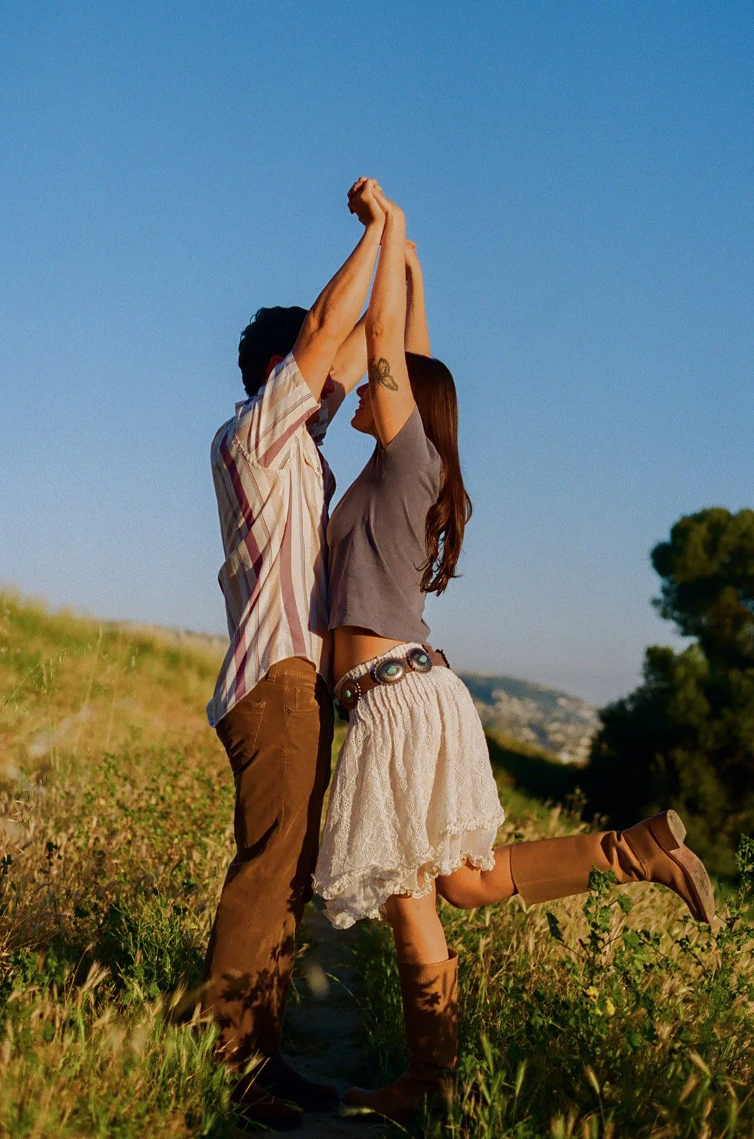 A couple posing for film engagement photos