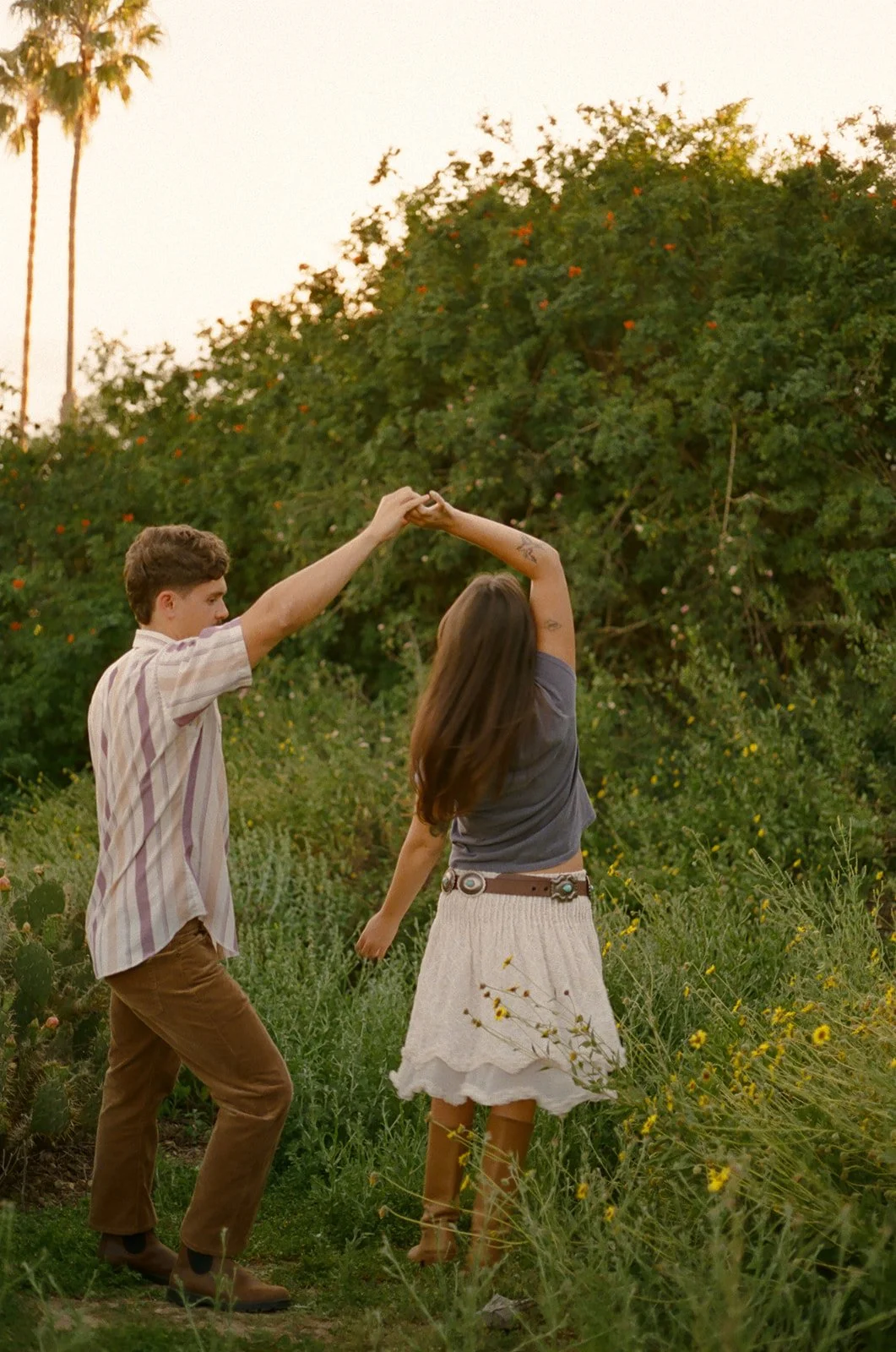 A couple dancing in a field for Laguna Beach engagement photos