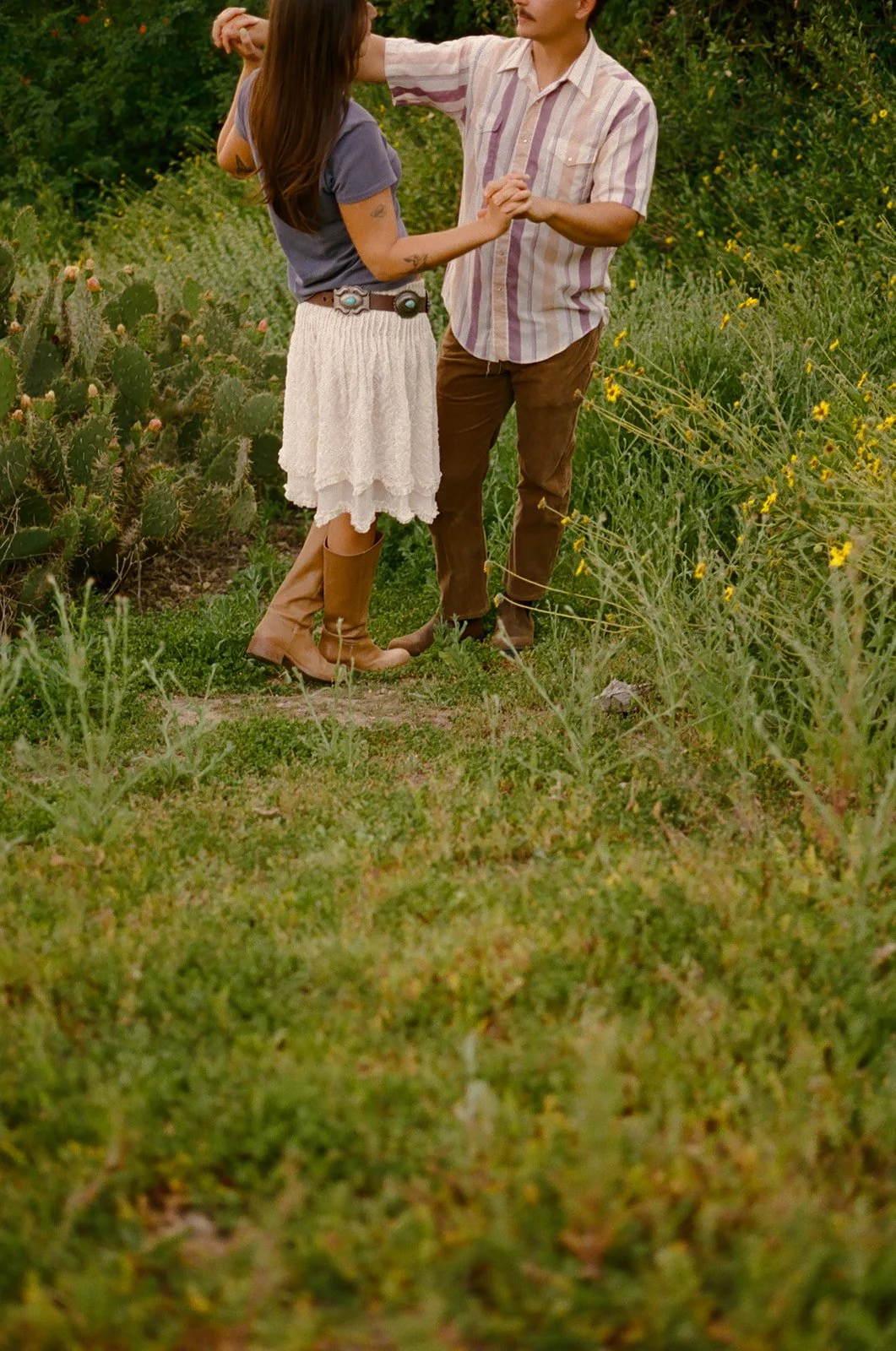 A couple dancing in a field for Laguna Beach engagement photos