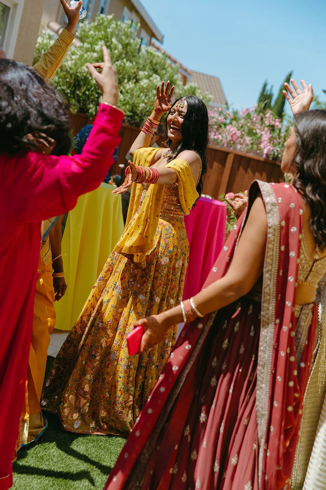 A bride dancing at her Mehndi ceremony, honoring wedding traditions