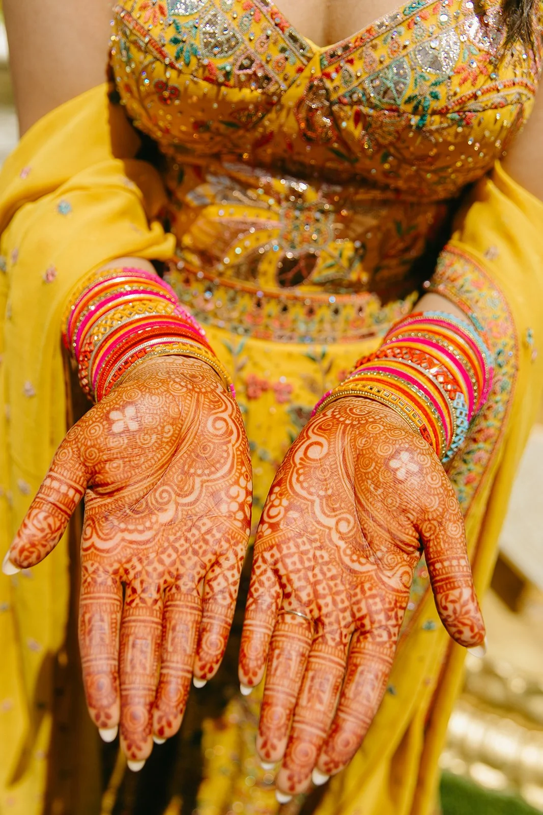 A bride showing off her henna for her Indian wedding