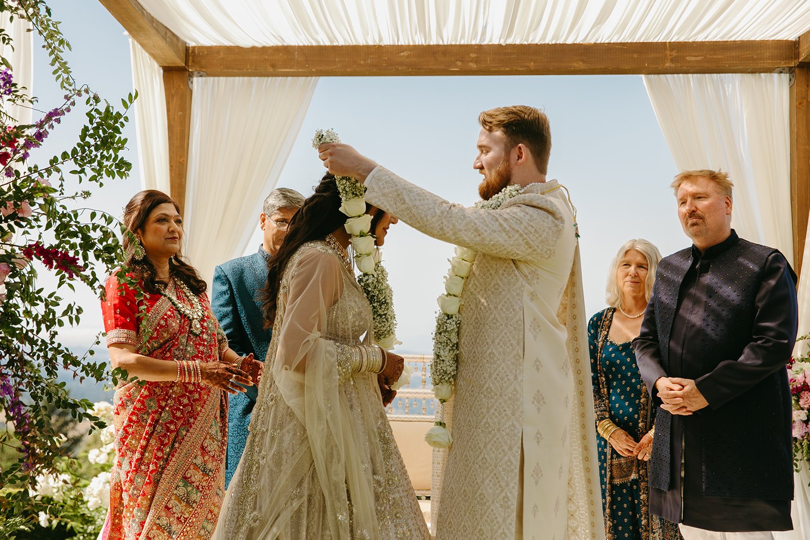 A garland exchange honoring wedding traditions at an Indian wedding
