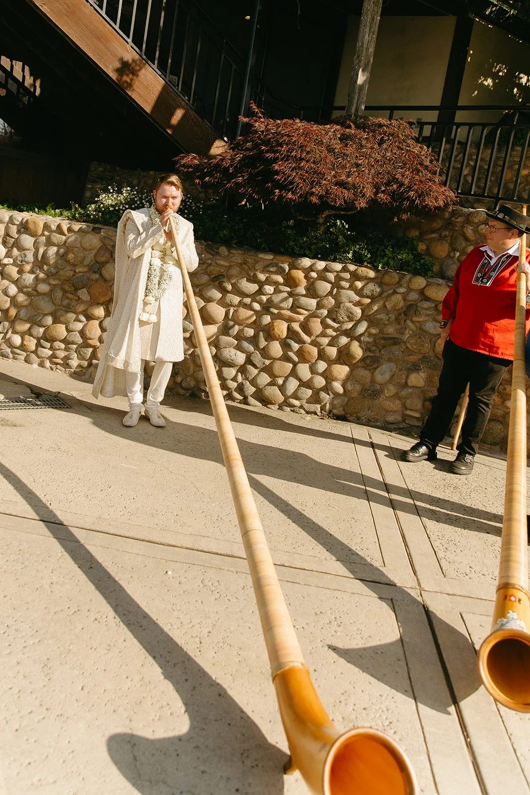 Swiss men playing alphorns at a Swiss wedding