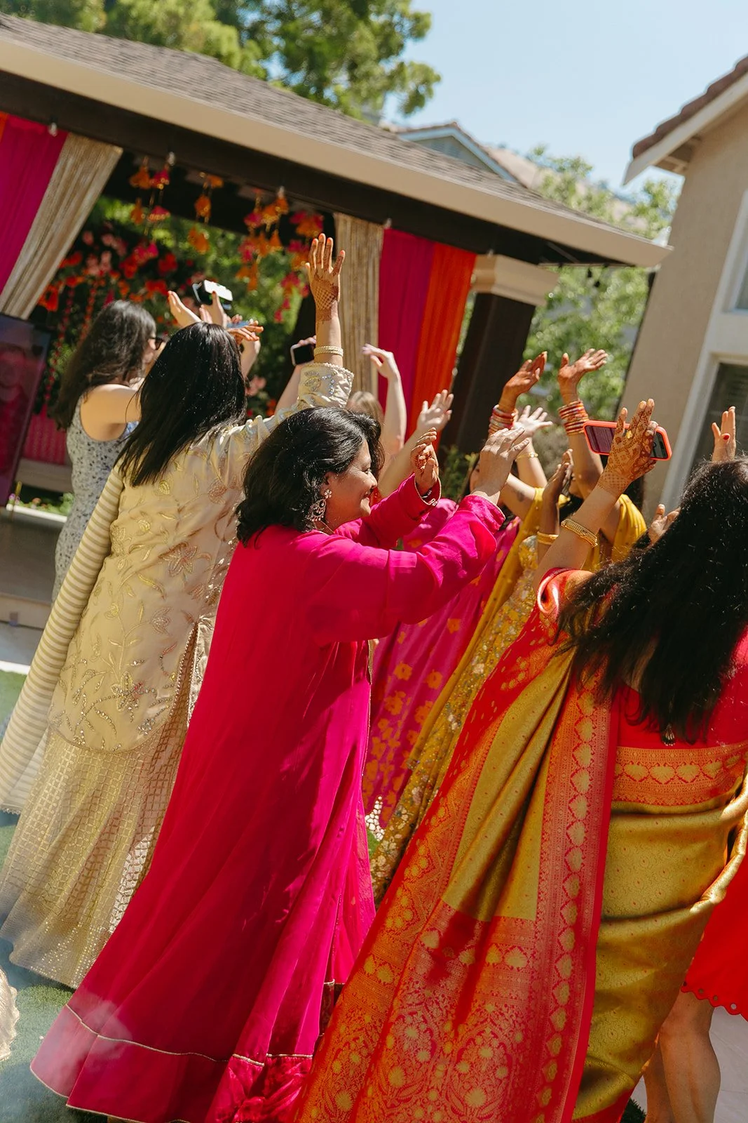 Guests at a Mehndi ceremony dancing for wedding traditions