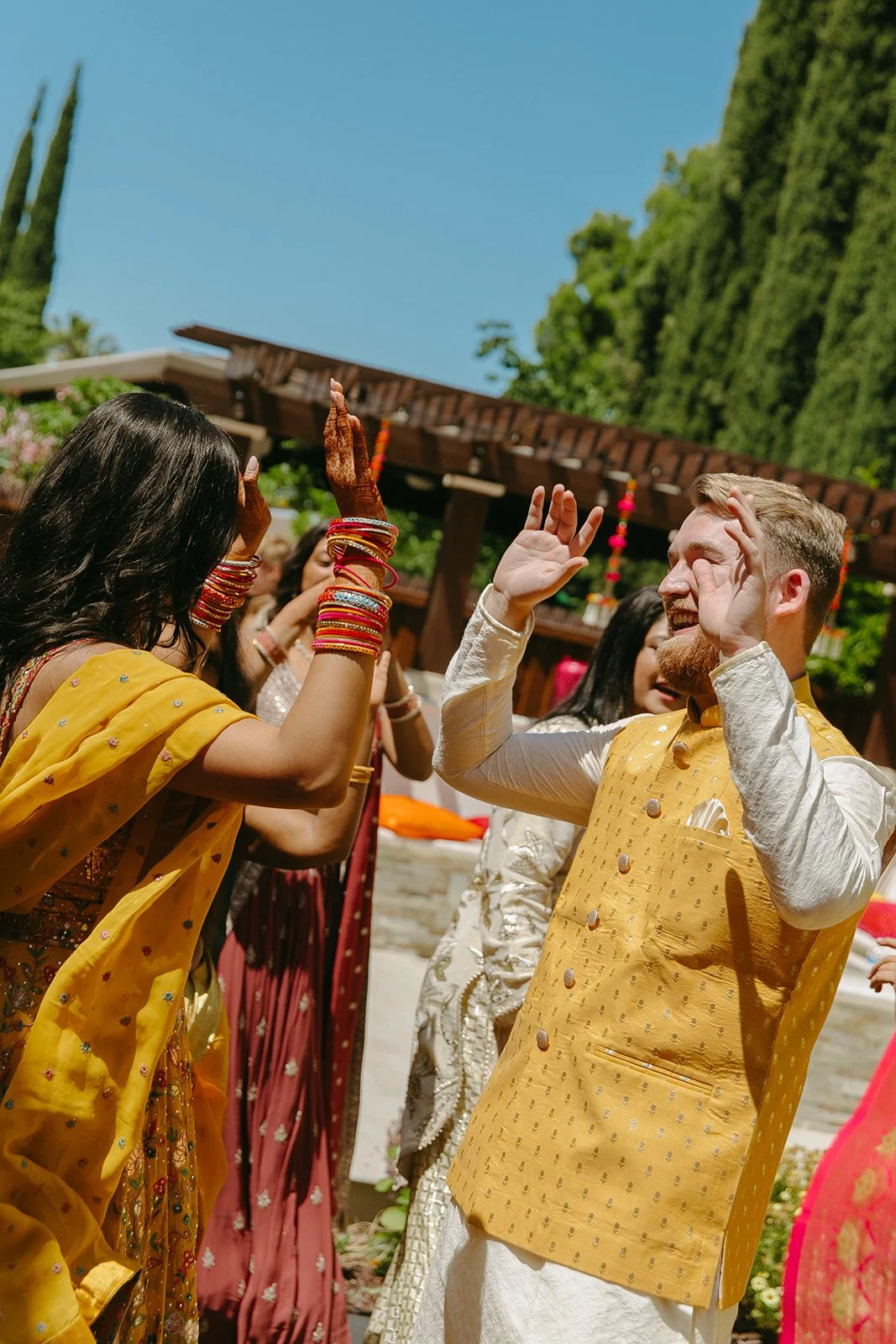 A bride and groom dancing at a Mehndi ceremony