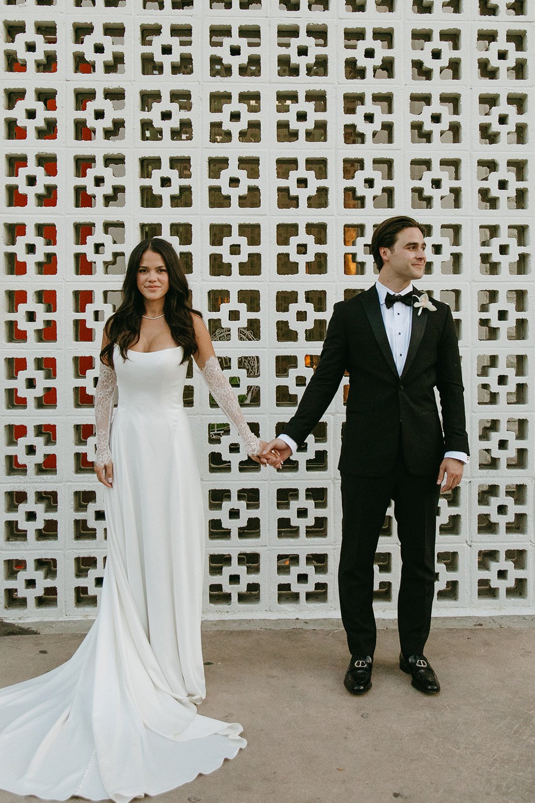 A bride and groom taking photos at a venue for Palm Springs weddings