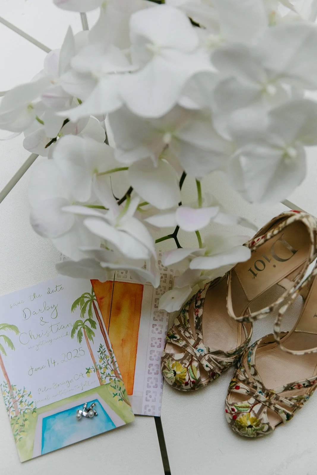 A wedding flat lay with shoes and flowers for a Palm Springs wedding