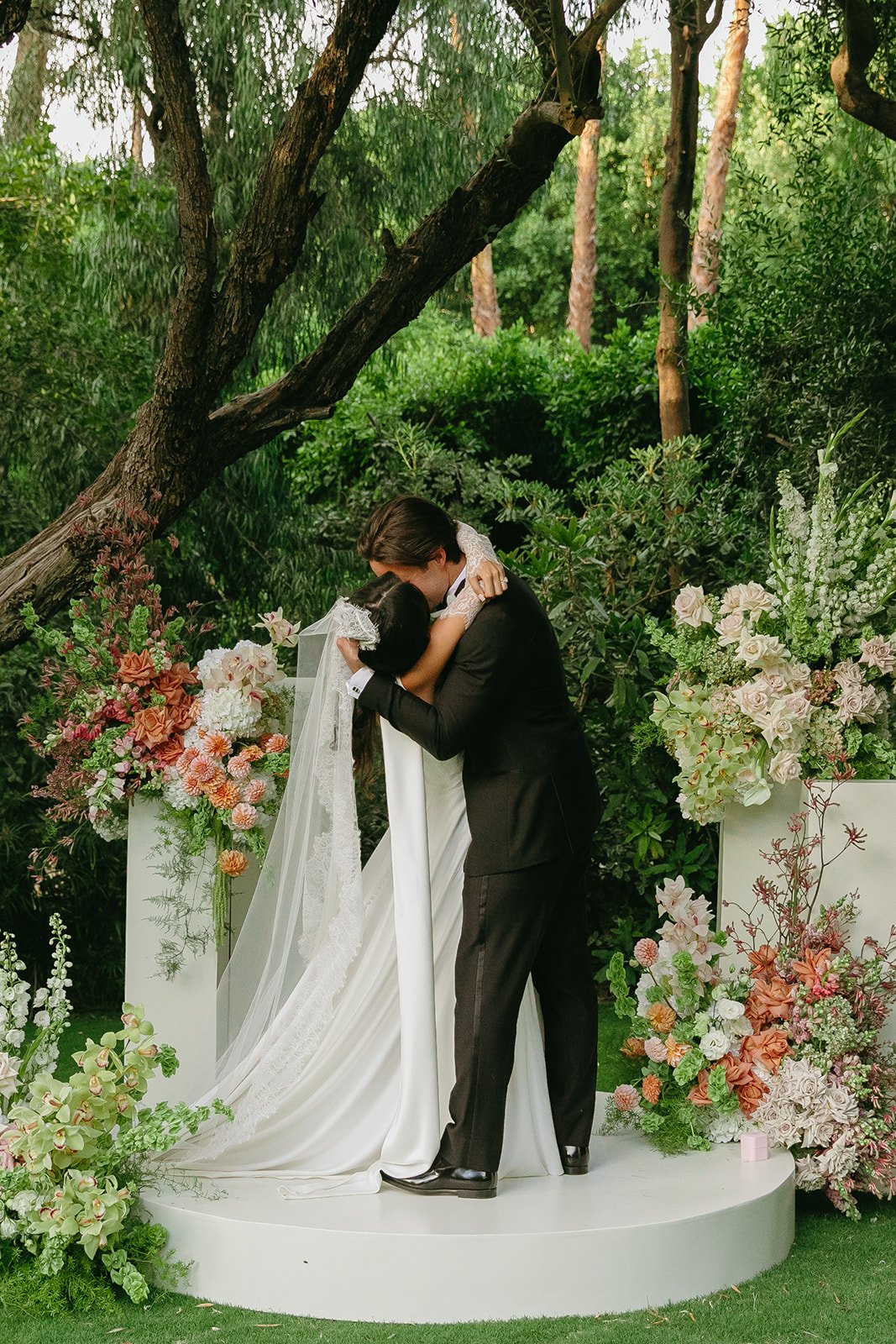 A bride and groom sharing their first kiss