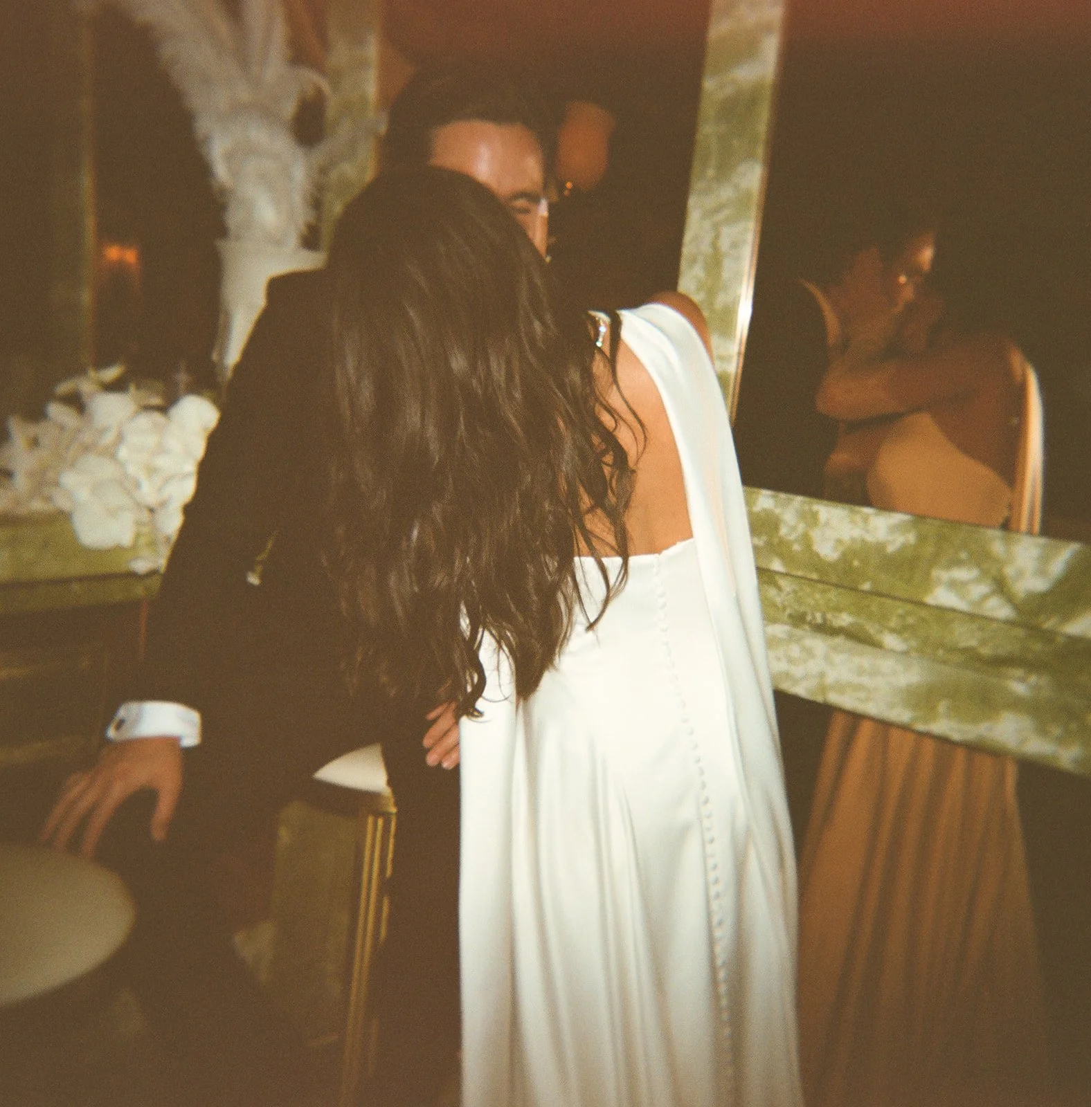 A bride and groom kissing after their wedding ceremony