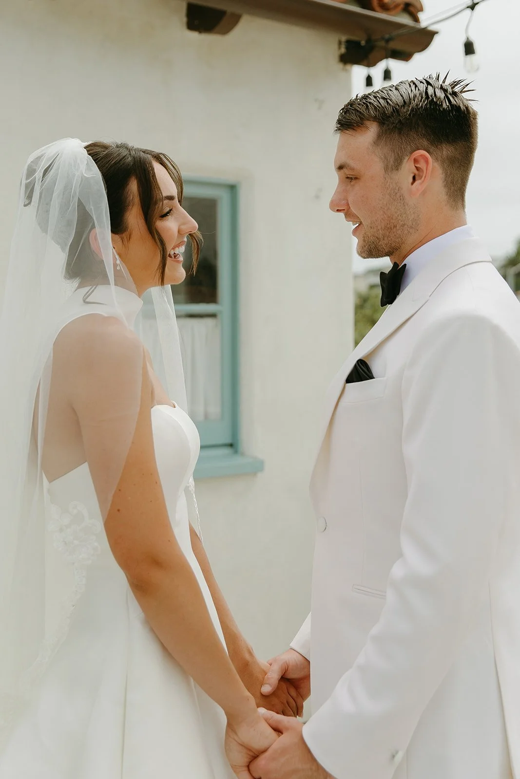 A bride and groom posing for first look wedding portraits at a san clemente wedding