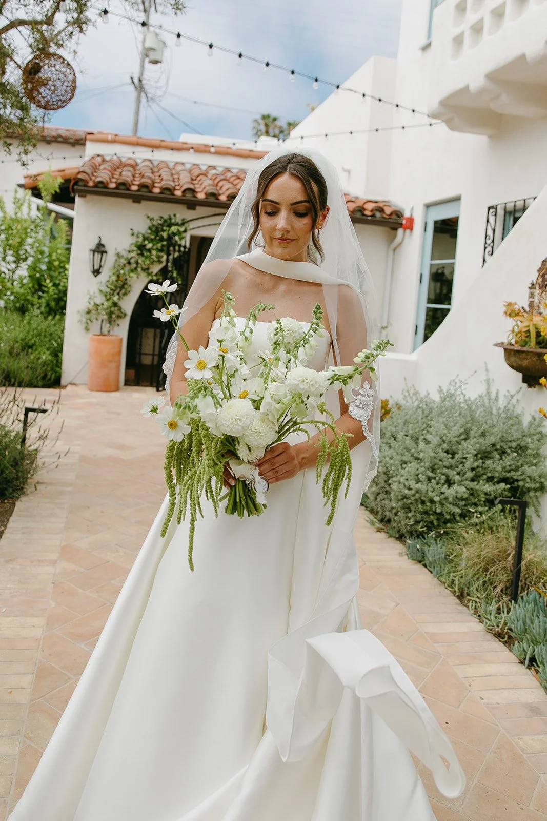 A bride posing for photos at her san clemente wedding