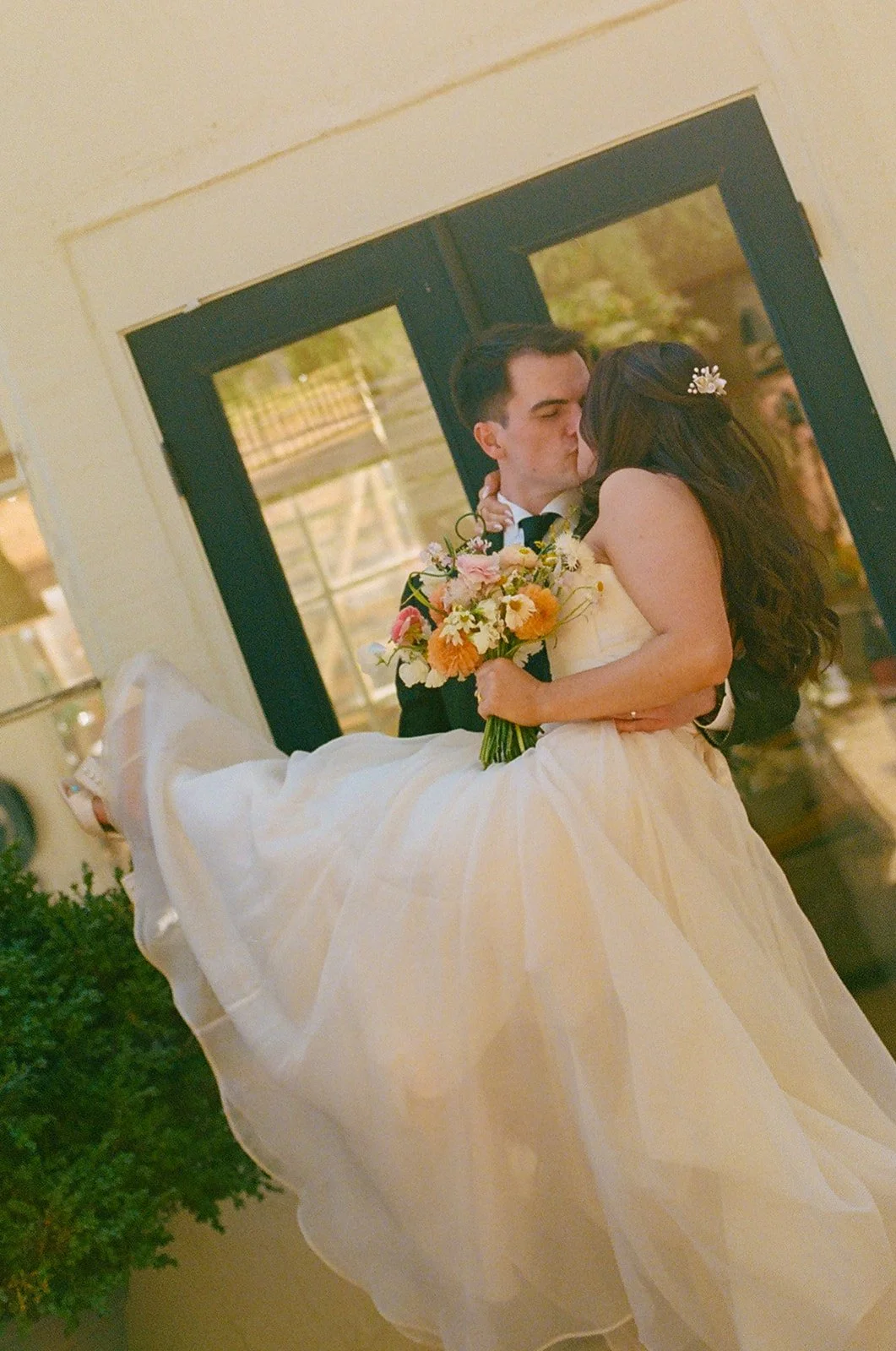 A bride and groom kissing at their small wedding