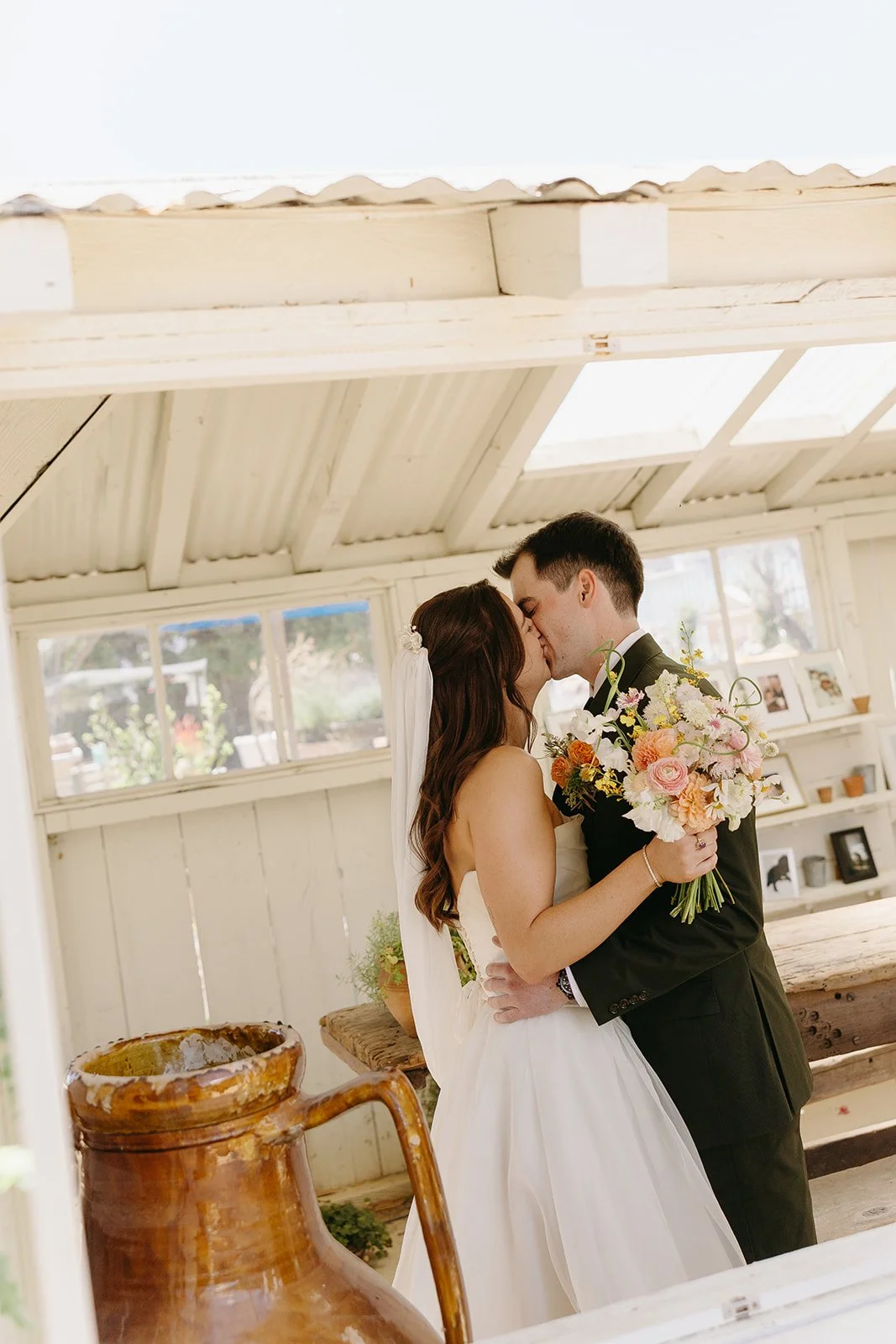 A bride and groom kissing during their first look