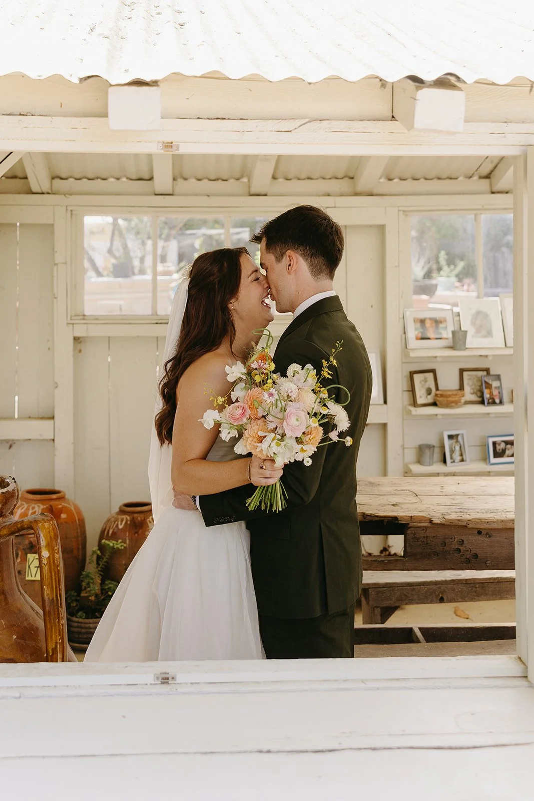 A bride and groom kissing during their first look