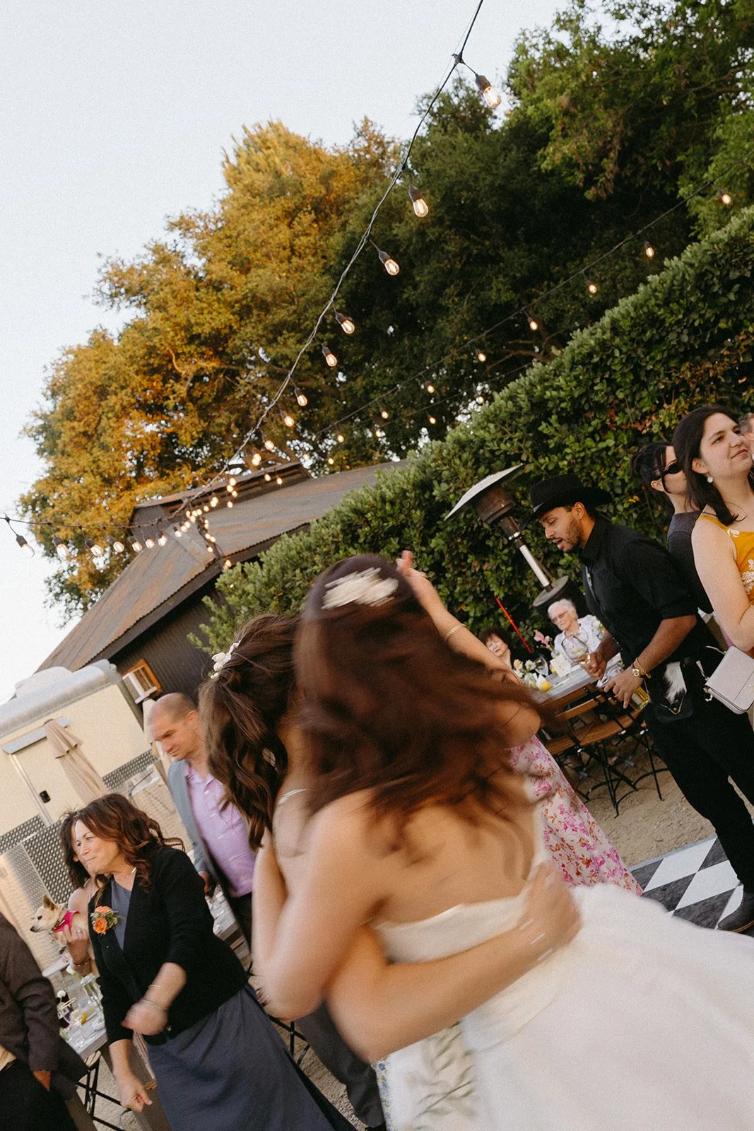 A bride dancing with wedding guests in a blog about small wedding ideas