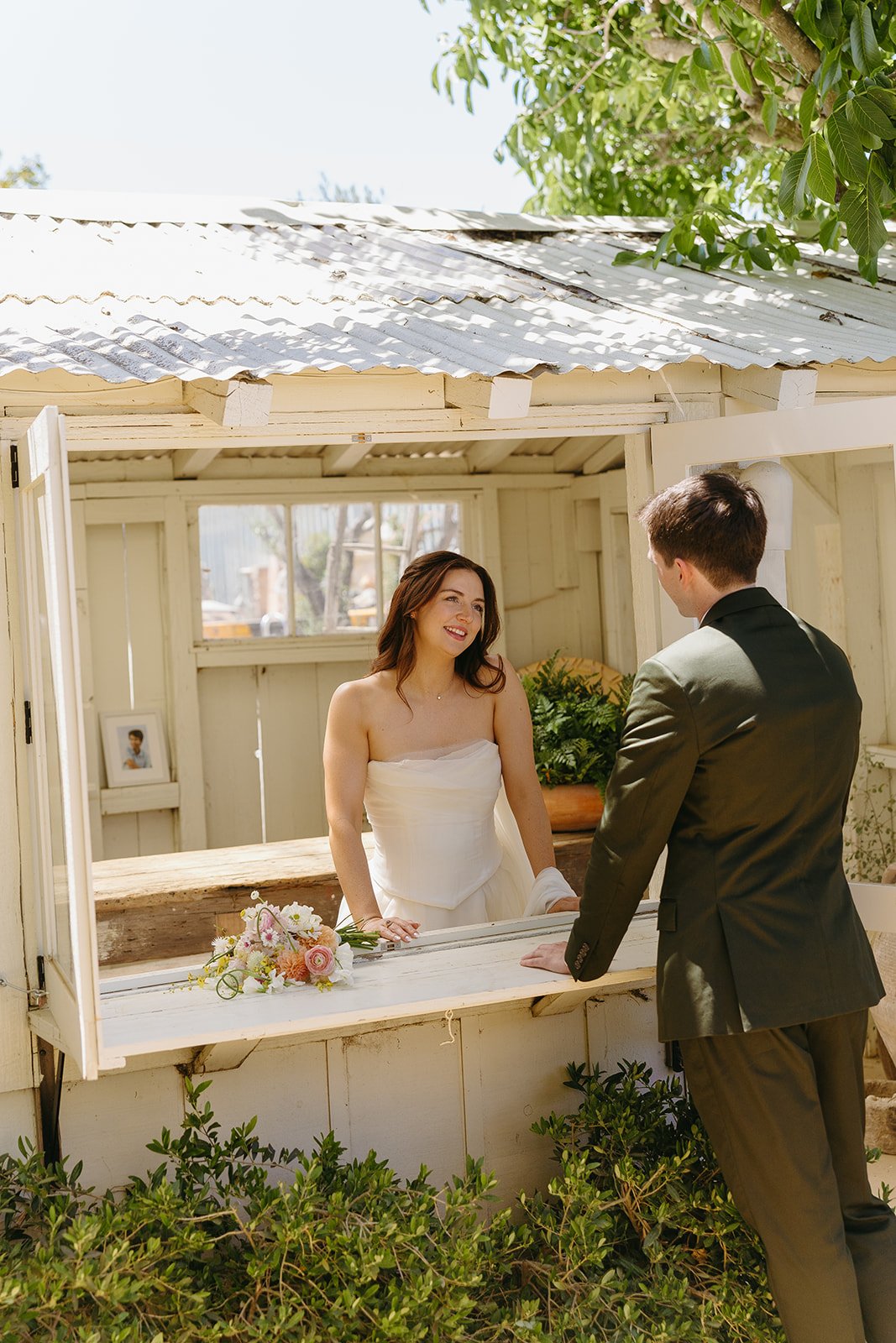 A bride and groom taking portraits in a blog post about small wedding ideas
