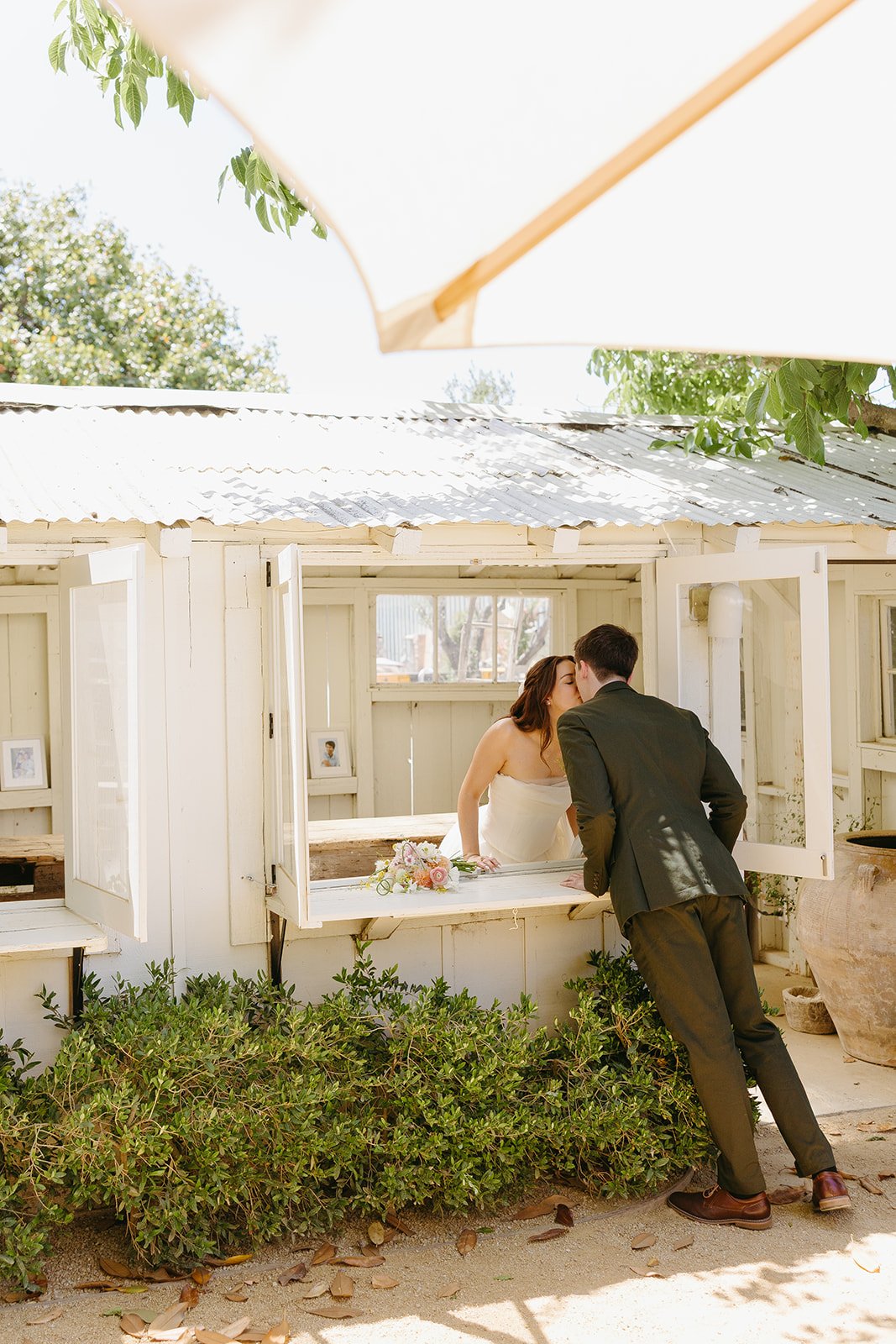 A bride and groom taking portraits in a blog post about small wedding ideas