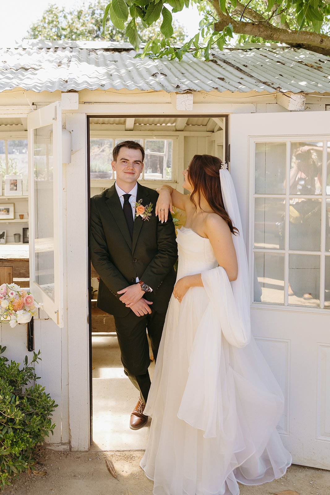 A bride and groom taking portraits in a blog post about small wedding ideas