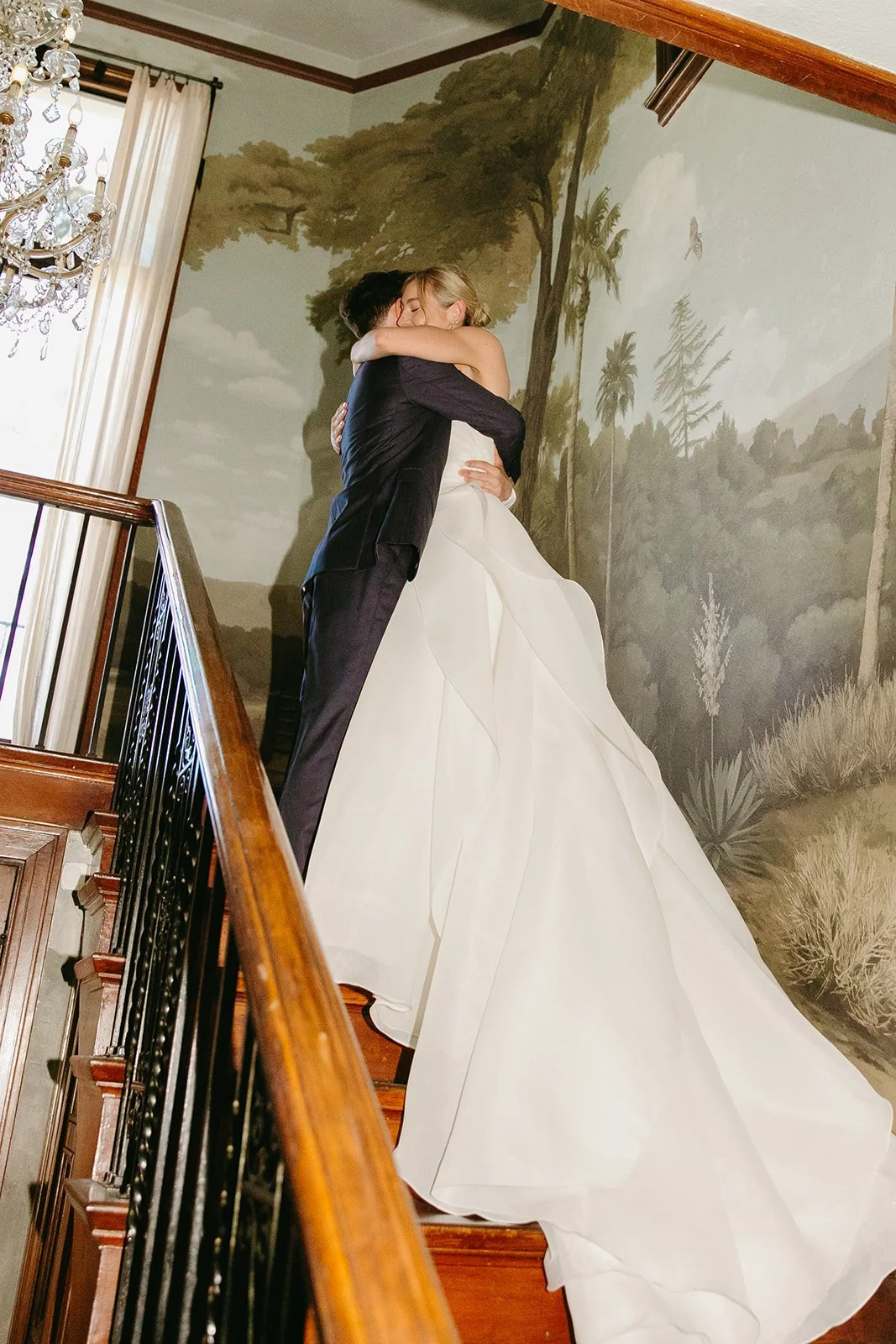 A bride and groom hugging inside of their estate wedding venue