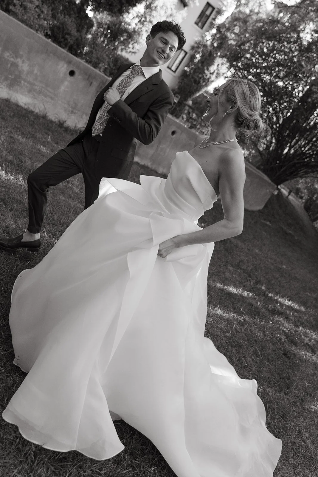A bride and groom running during their chic Los Angeles wedding