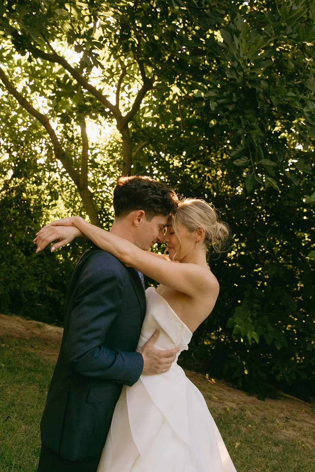 A bride and groom posing for romantic wedding photos