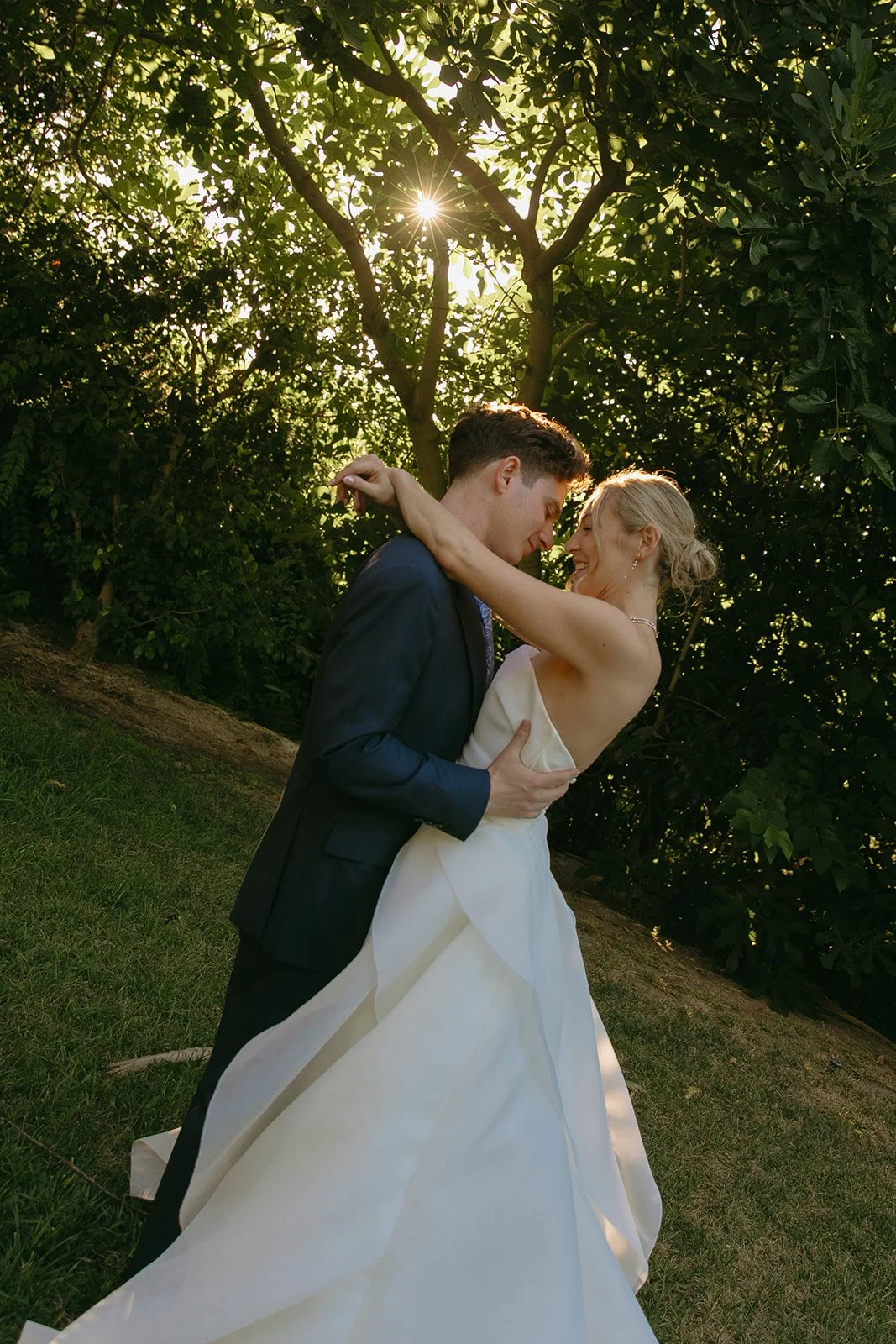 A bride and groom posing for romantic wedding photos