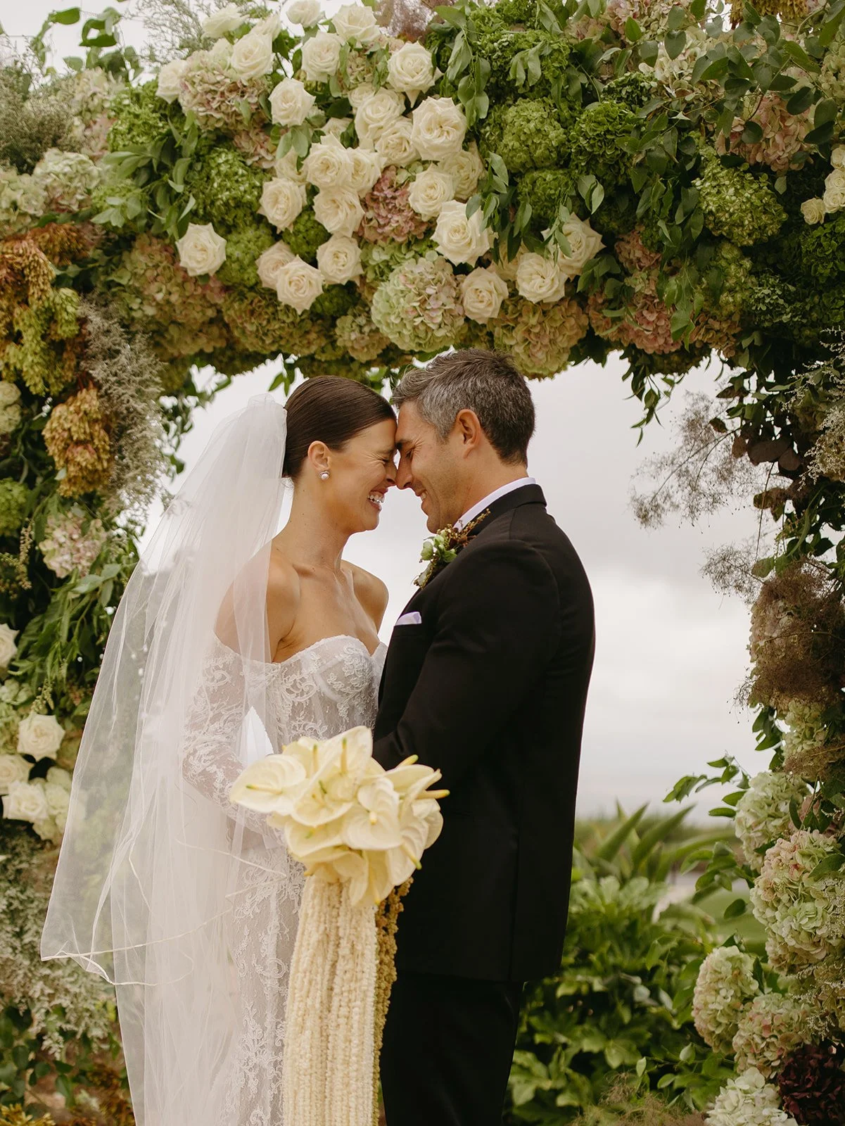 A bride and groom kissing at the ceremony site at Terranea Resort