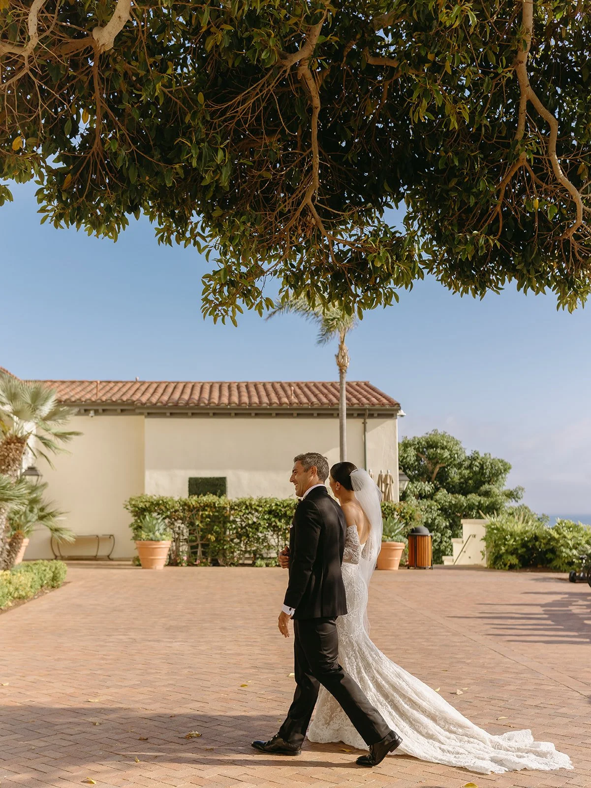 A bride and groom walking in their wedding venue