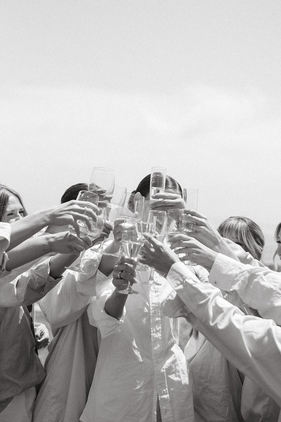 Bridesmaids clinking glasses during getting ready wedding photos