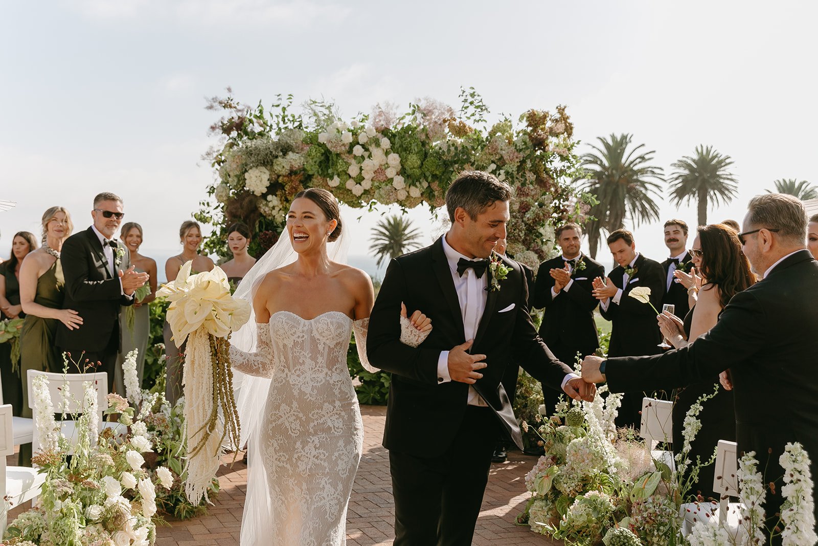 A bride and groom exiting their wedding ceremony