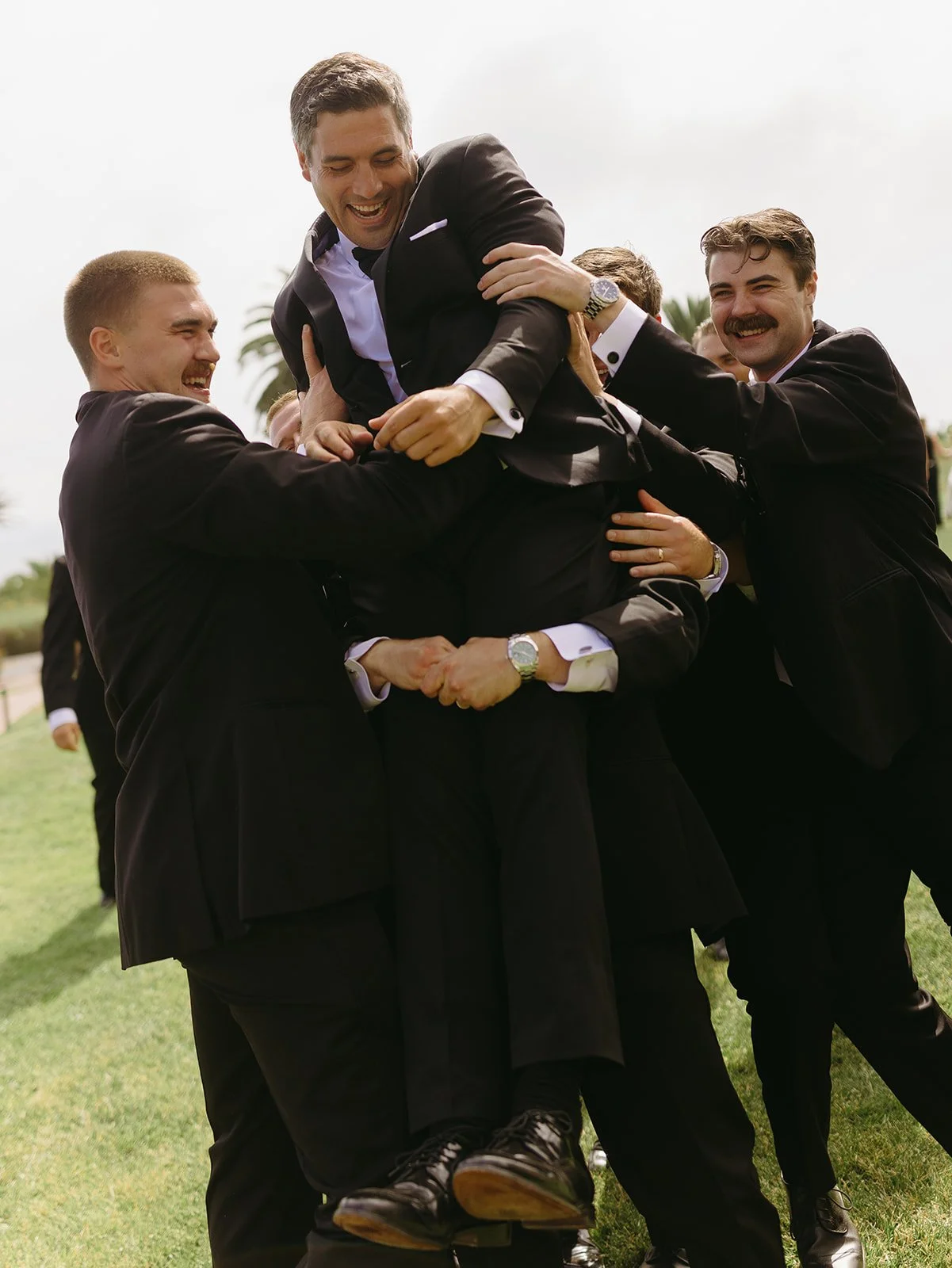 A groom and groomsmen taking photos at Terranea Resort