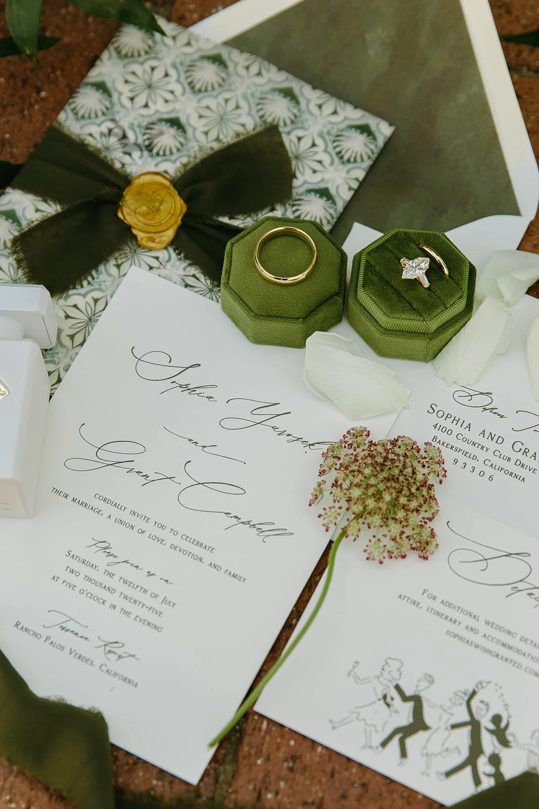 A wedding flat lay with a green wedding aesthetic