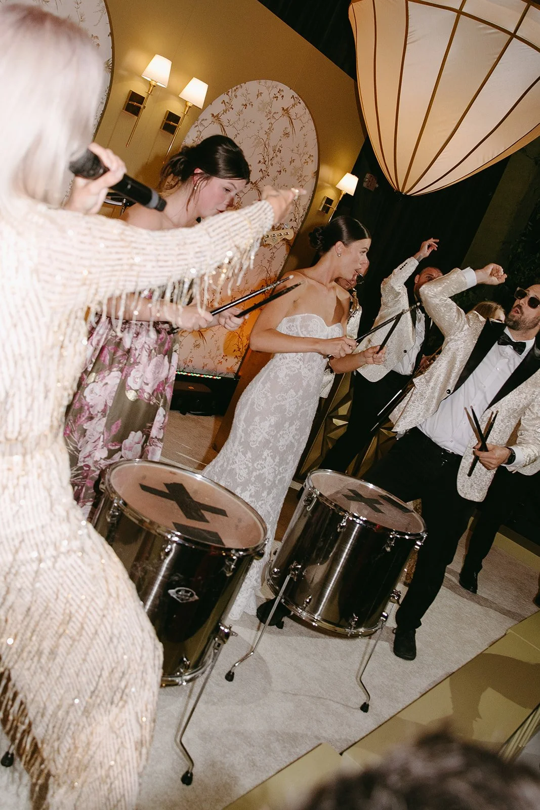 A live band performing at a wedding reception with the bride and groom on stage