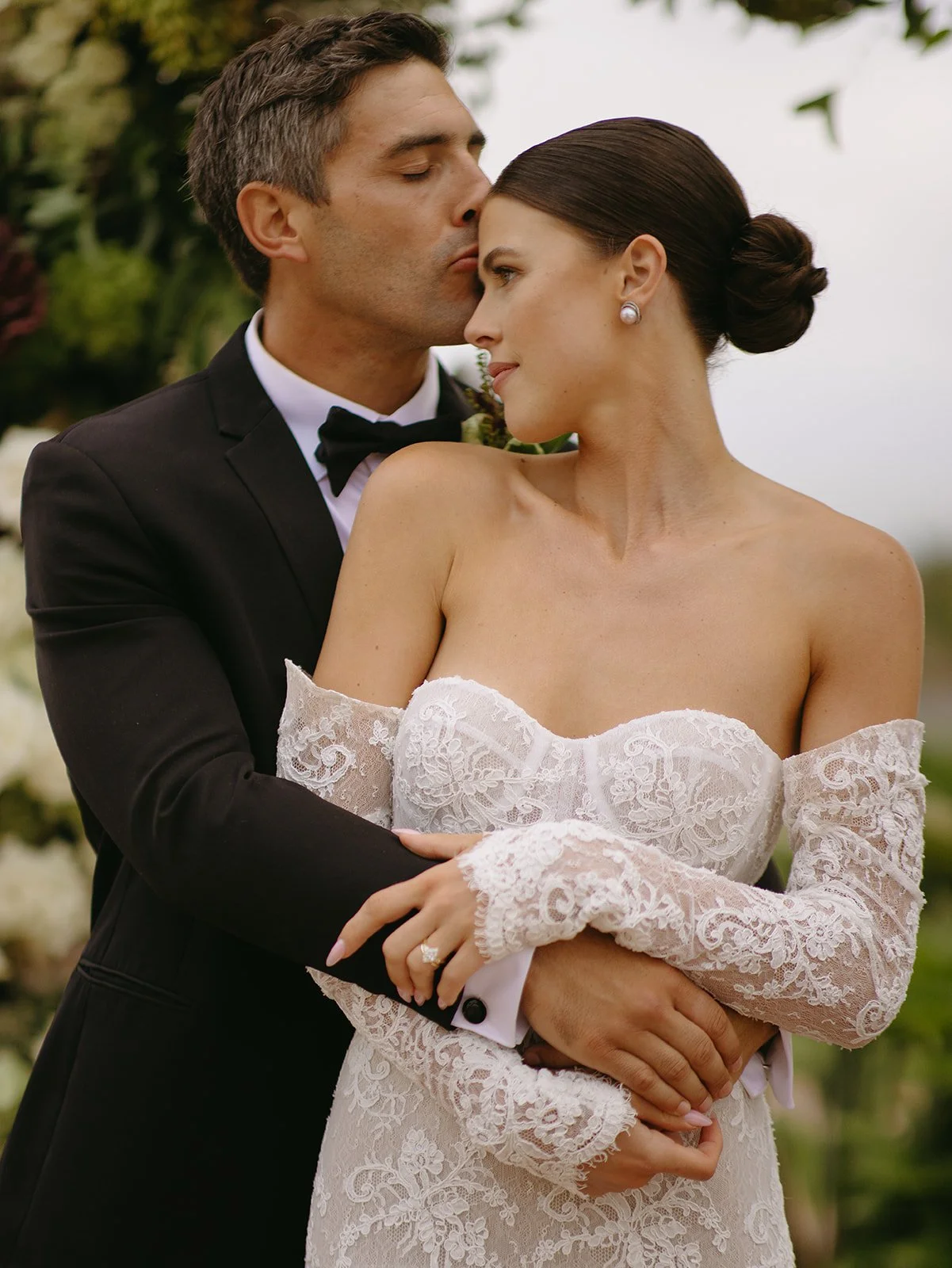A bride and groom posing for wedding photos