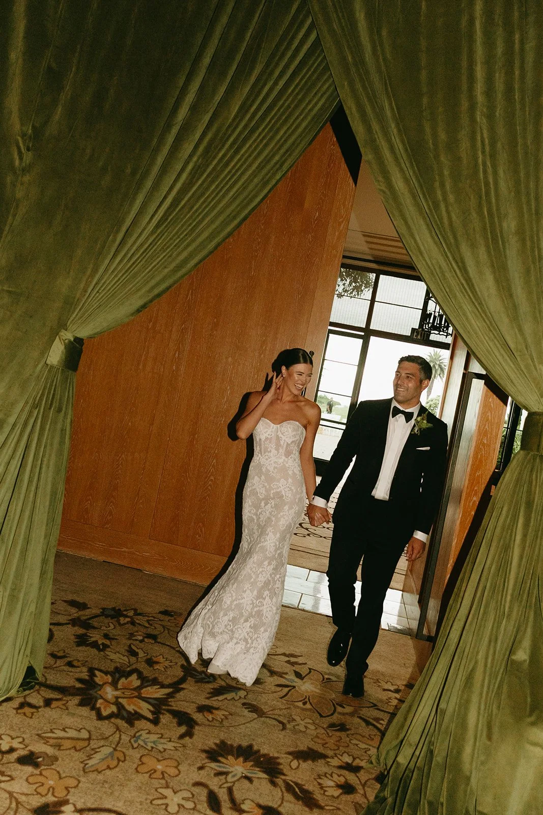 A bride and groom entering their wedding reception