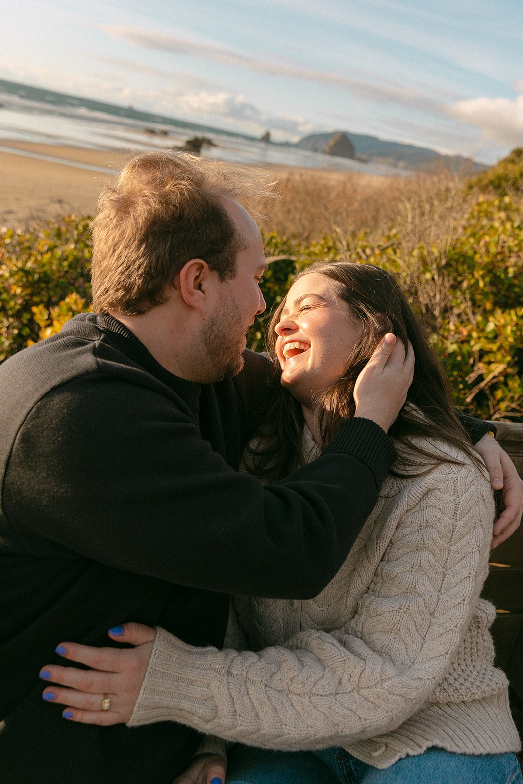 A couple taking choosing where engagement photos on Cannon Beach
