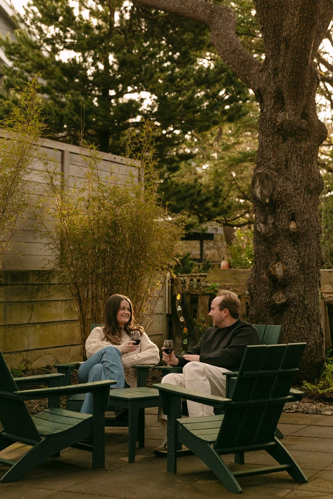 A couple following romantic engagement photo ideas and taking photos at a family vacation home