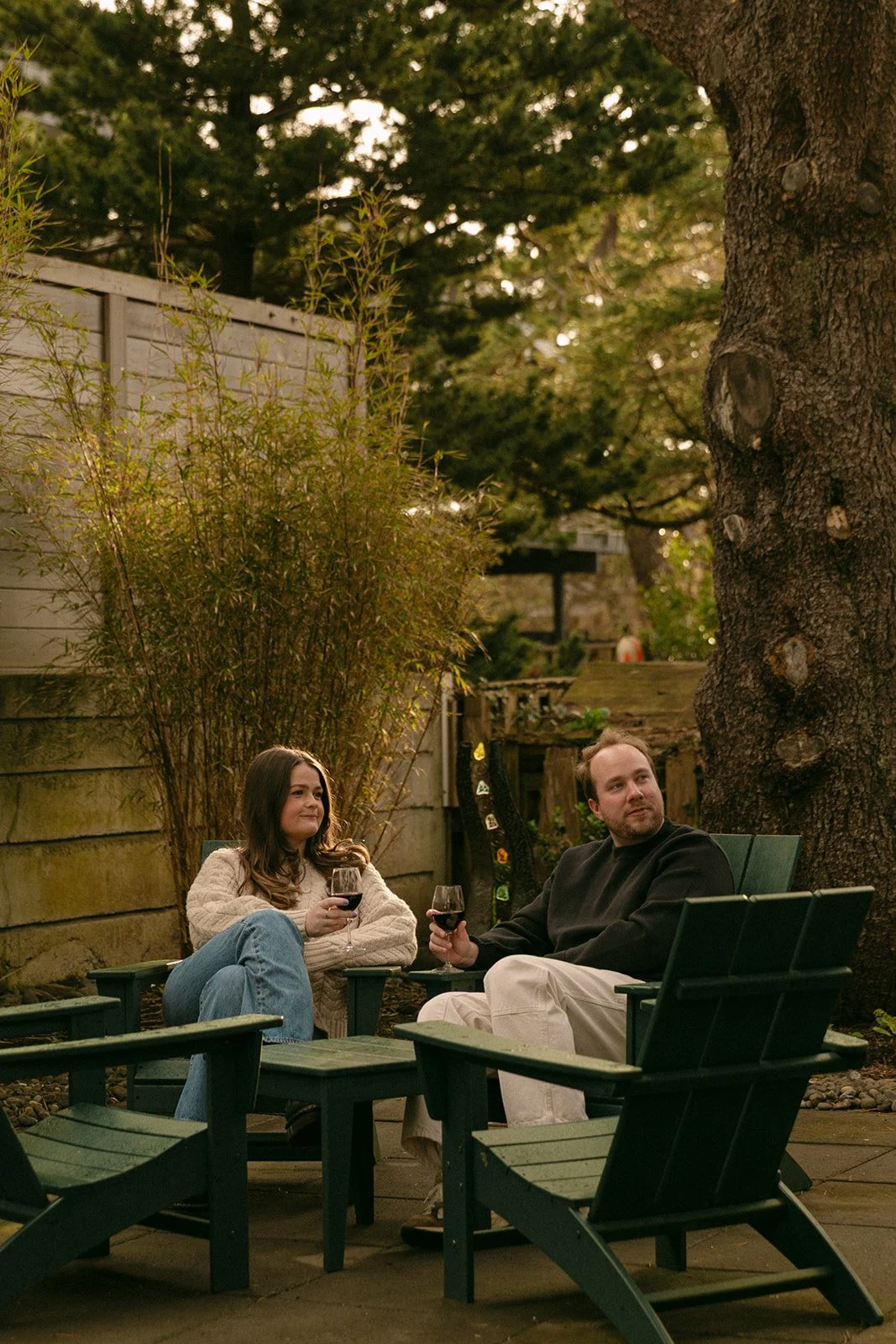 A couple following romantic engagement photo ideas and taking photos at a family vacation home